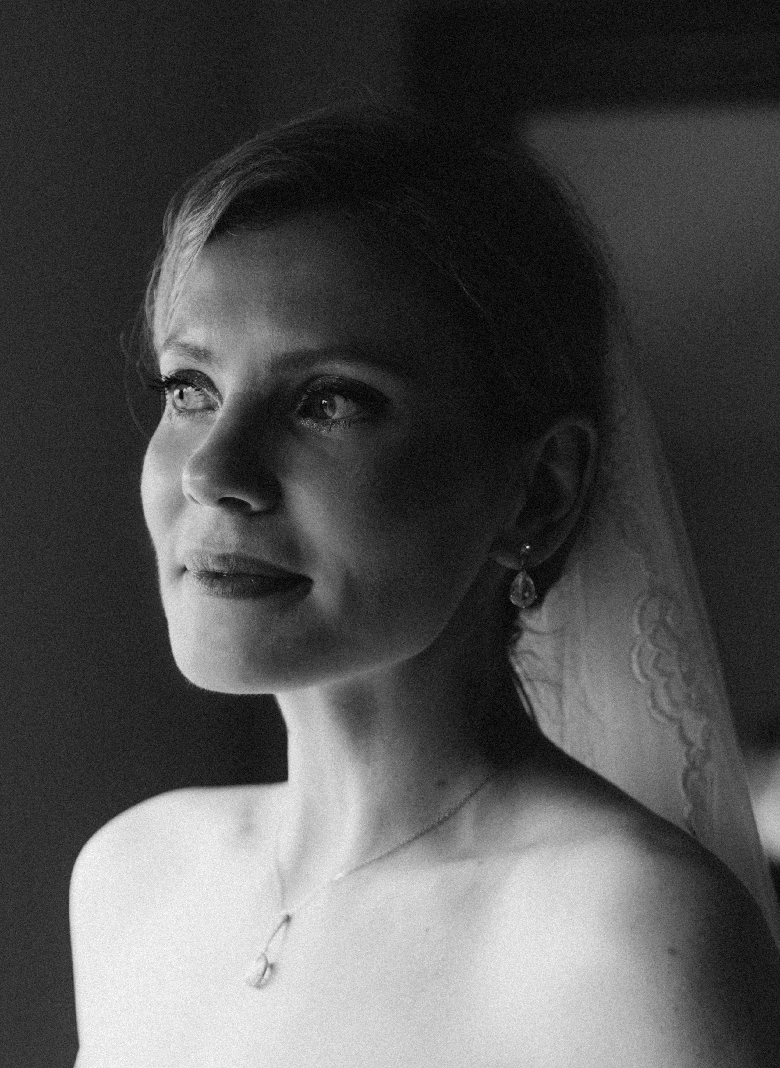 Bride walking Adirondack hiking trail with veil flowing.