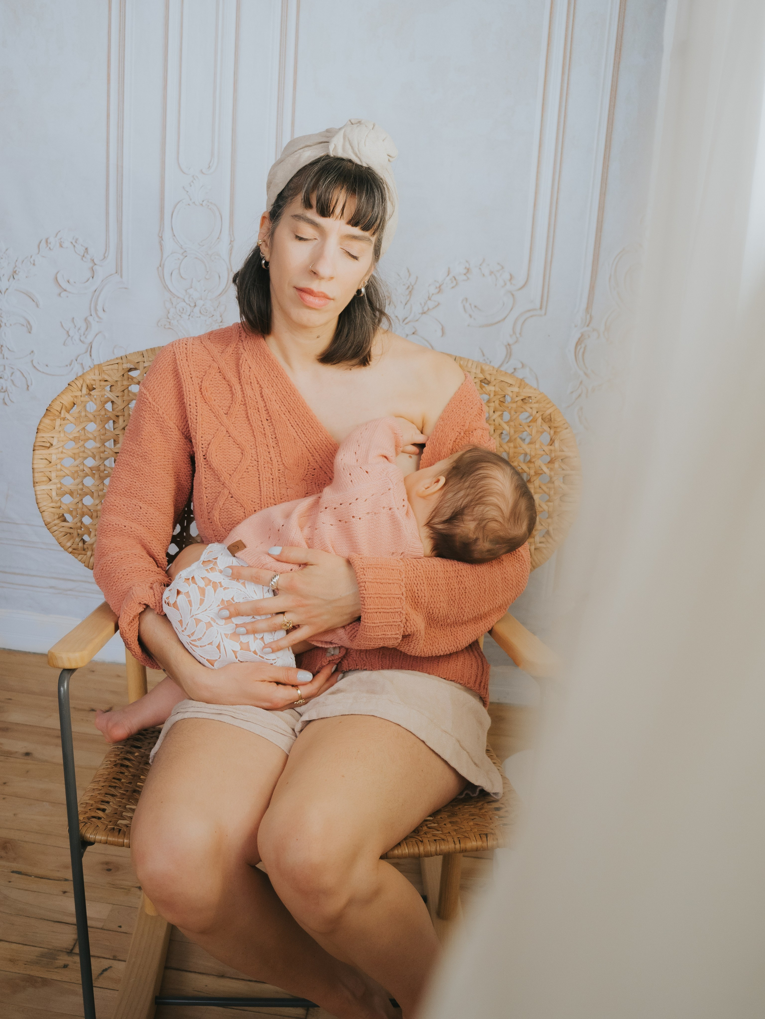 Woman breastfeeding in a rocking chair.
