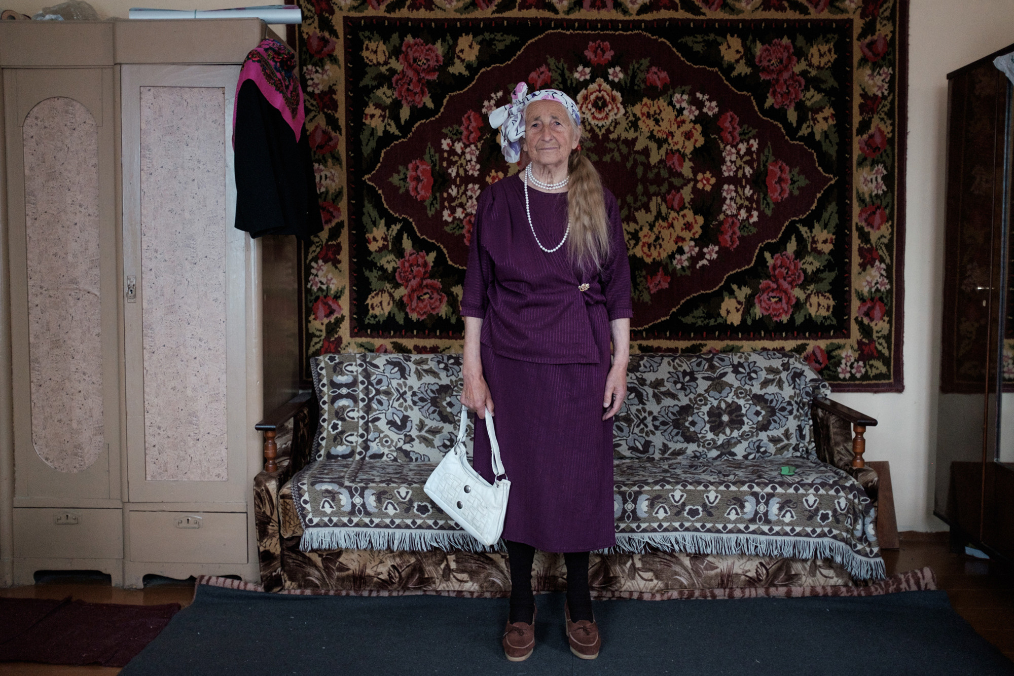 Vera is wearing a dress that was given to her by a friend who knew that purple is her favorite color.