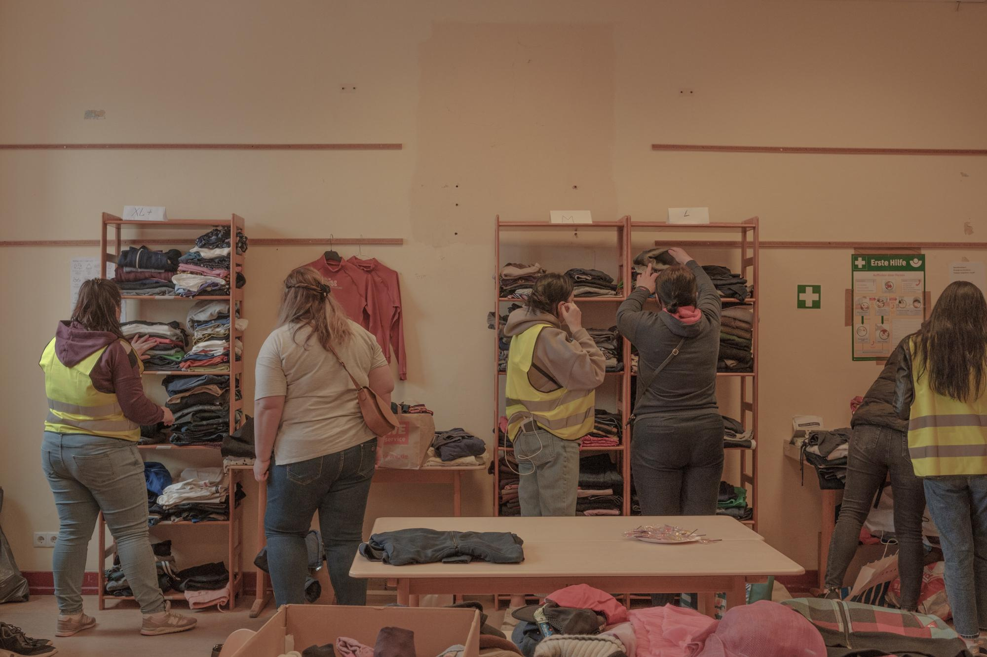 Lilia and Sveta together with other Ukrainians help to distribute clothes to refugees from Ukraine, Caritas, April, 2022