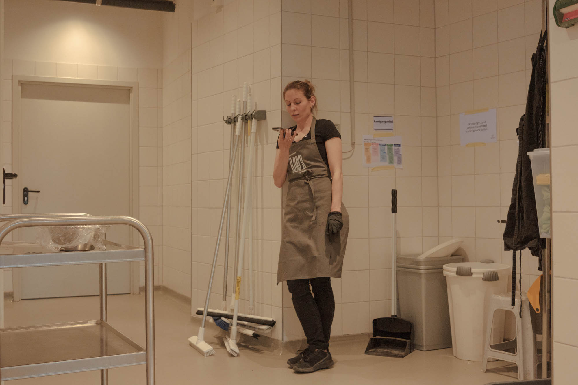 Olga is talking to her sister who stayed in Kiev by phone during a break during a week of Ukrainian cuisine in Hamburg, April, 2022