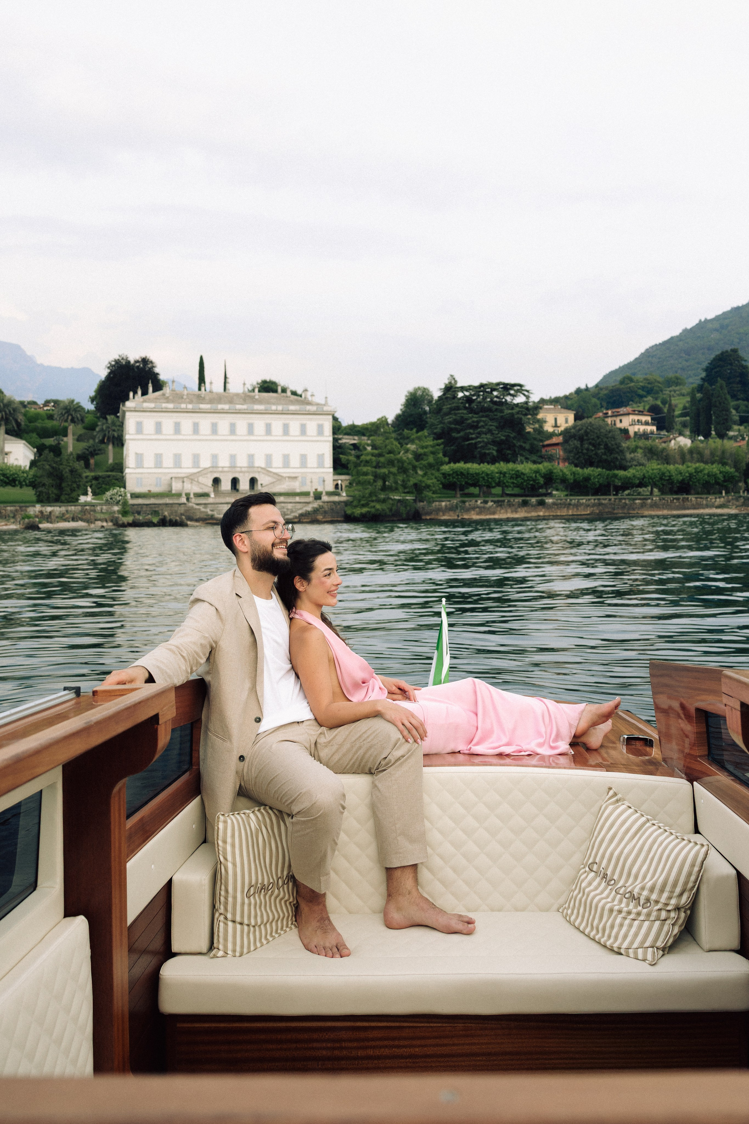 Romantic couple enjoying the view of Villa Melzi from a boat on Lake Como
