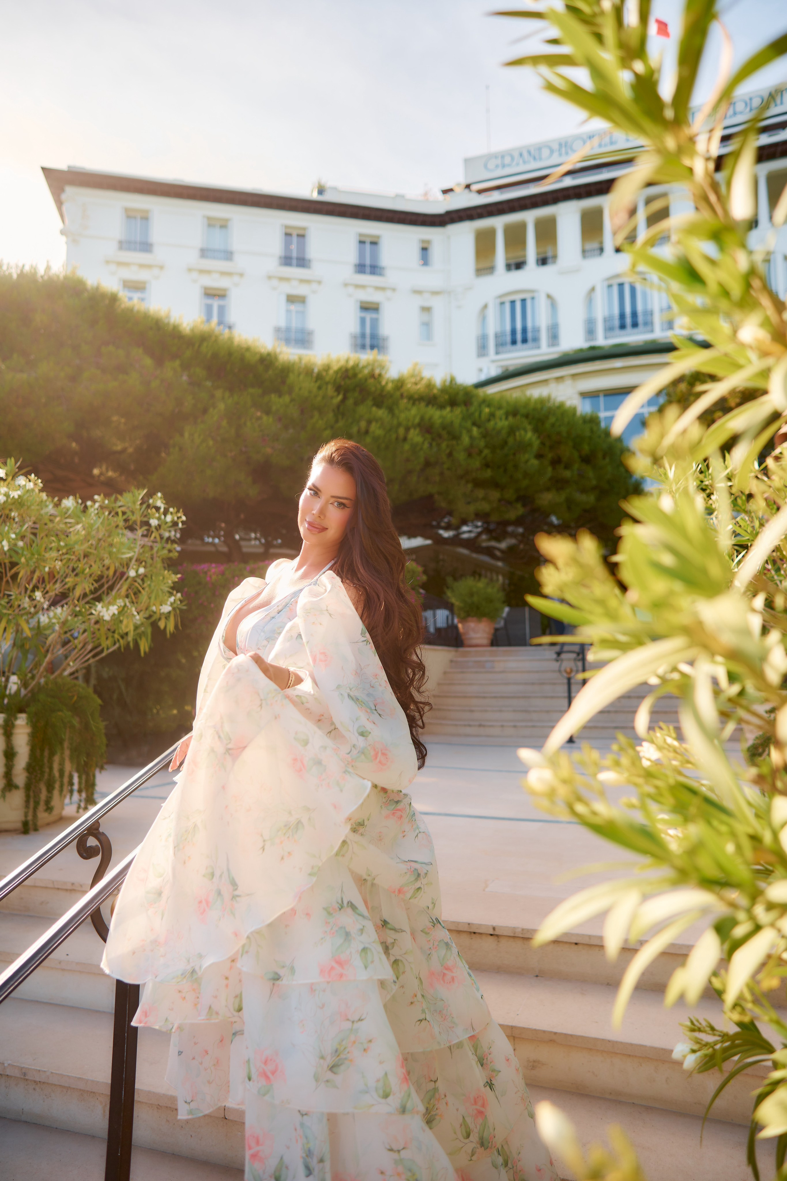 Luxury fashion shoot of woman in elegant dress near Grand Hotel Cap Ferrat exterior