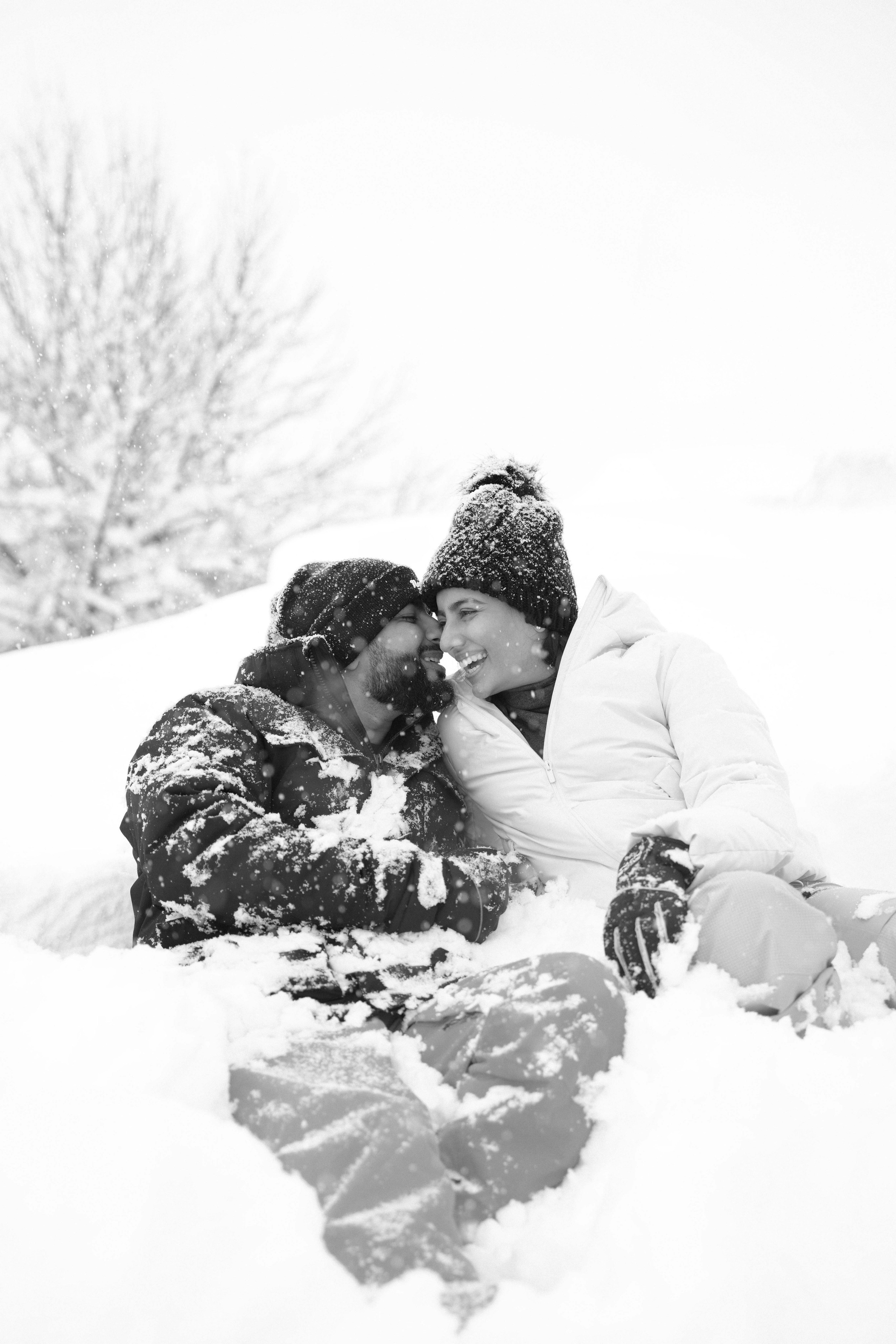 Couple laying in the snow in Gudauri Ski Resort