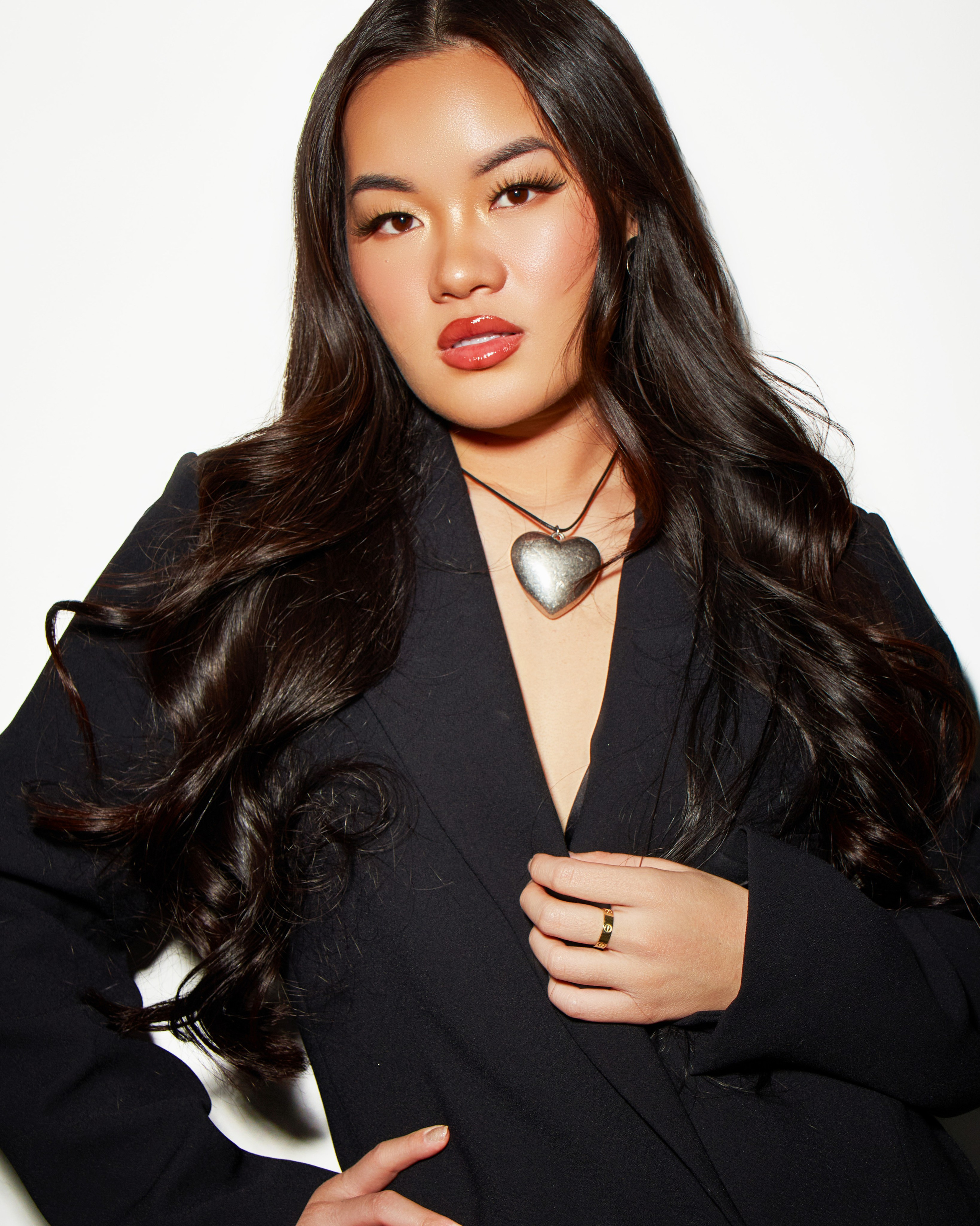 Utah empowerment portrait photography, confident woman in black blazer with heart necklace at Shtatolkina Studio