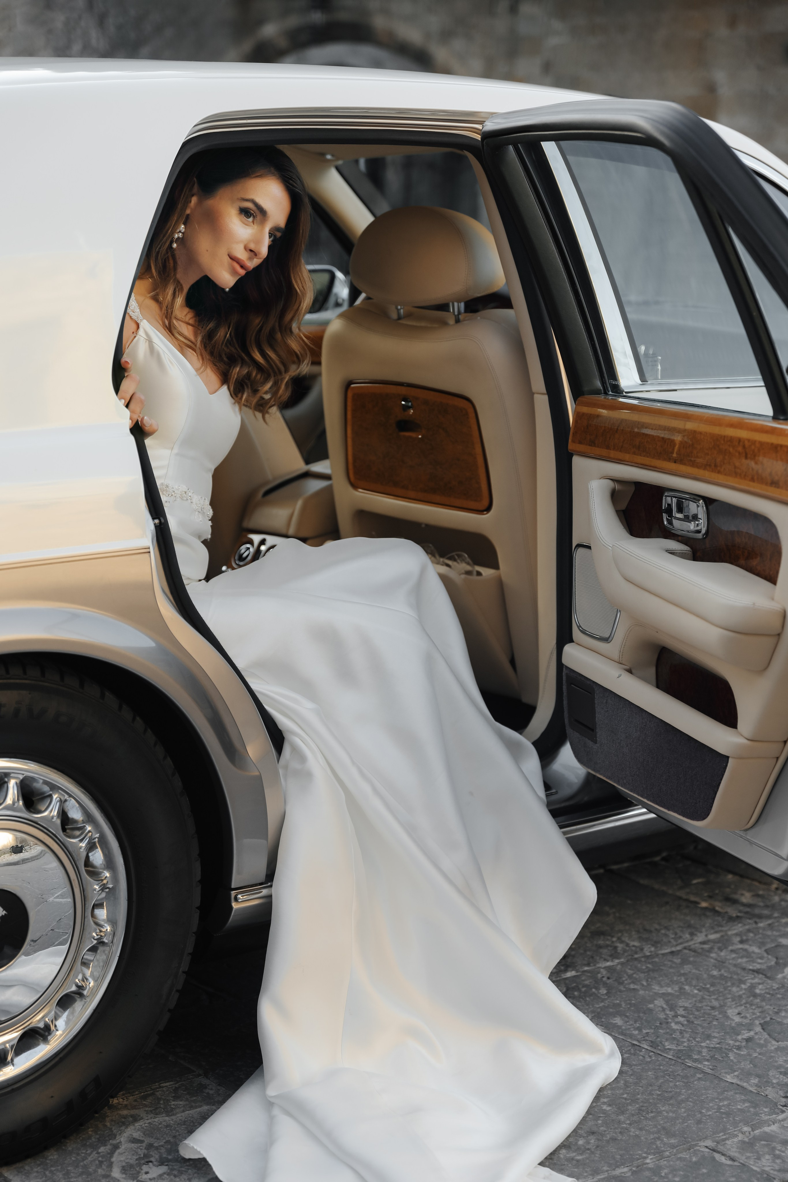 A portrait of a beautiful bride  in Rolls Royce in old town of Rhodes island, Greece
