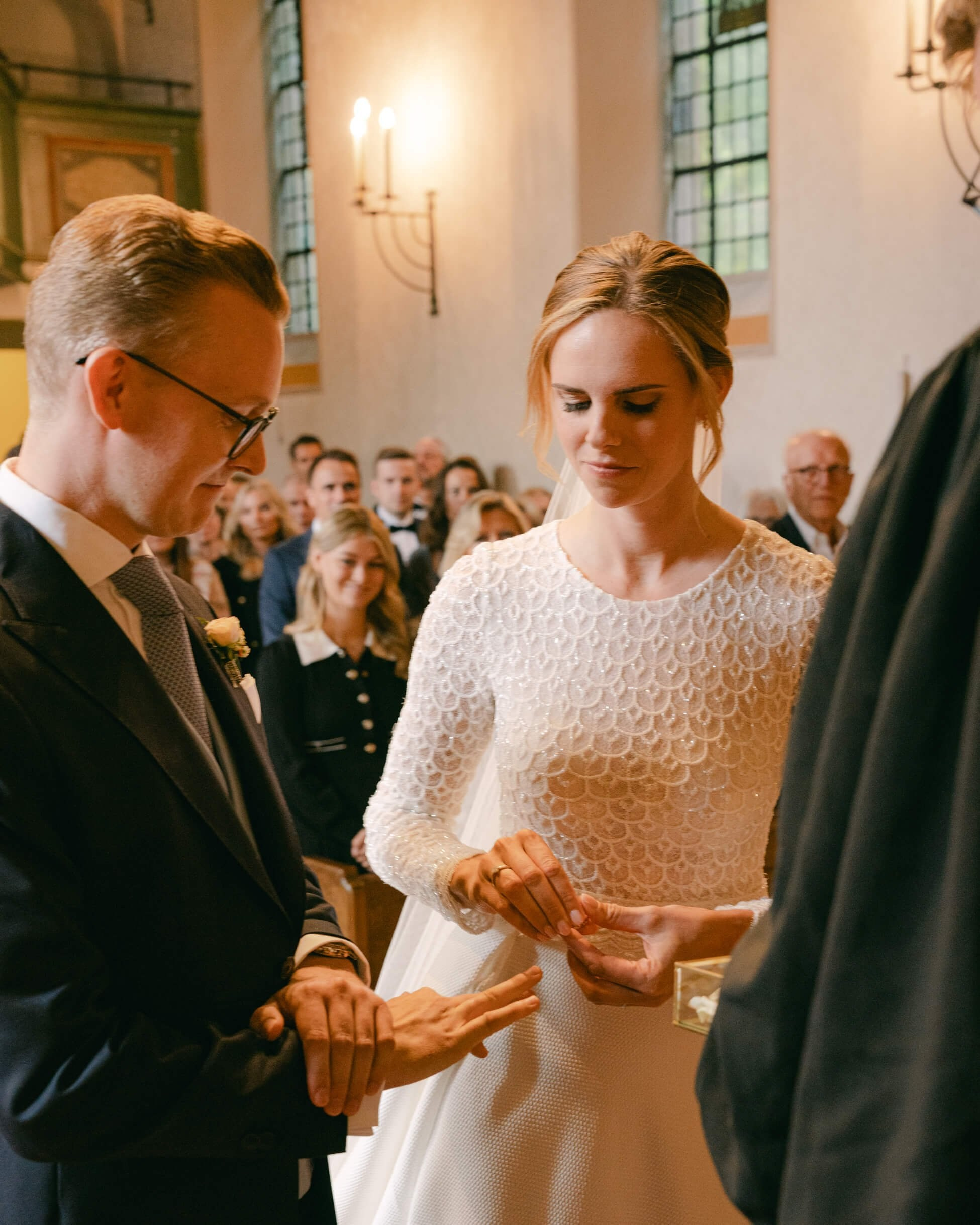 Ring exchange ceremony — groom placing ring on bride's finger, church wedding Frankfurt Villa Rothschild