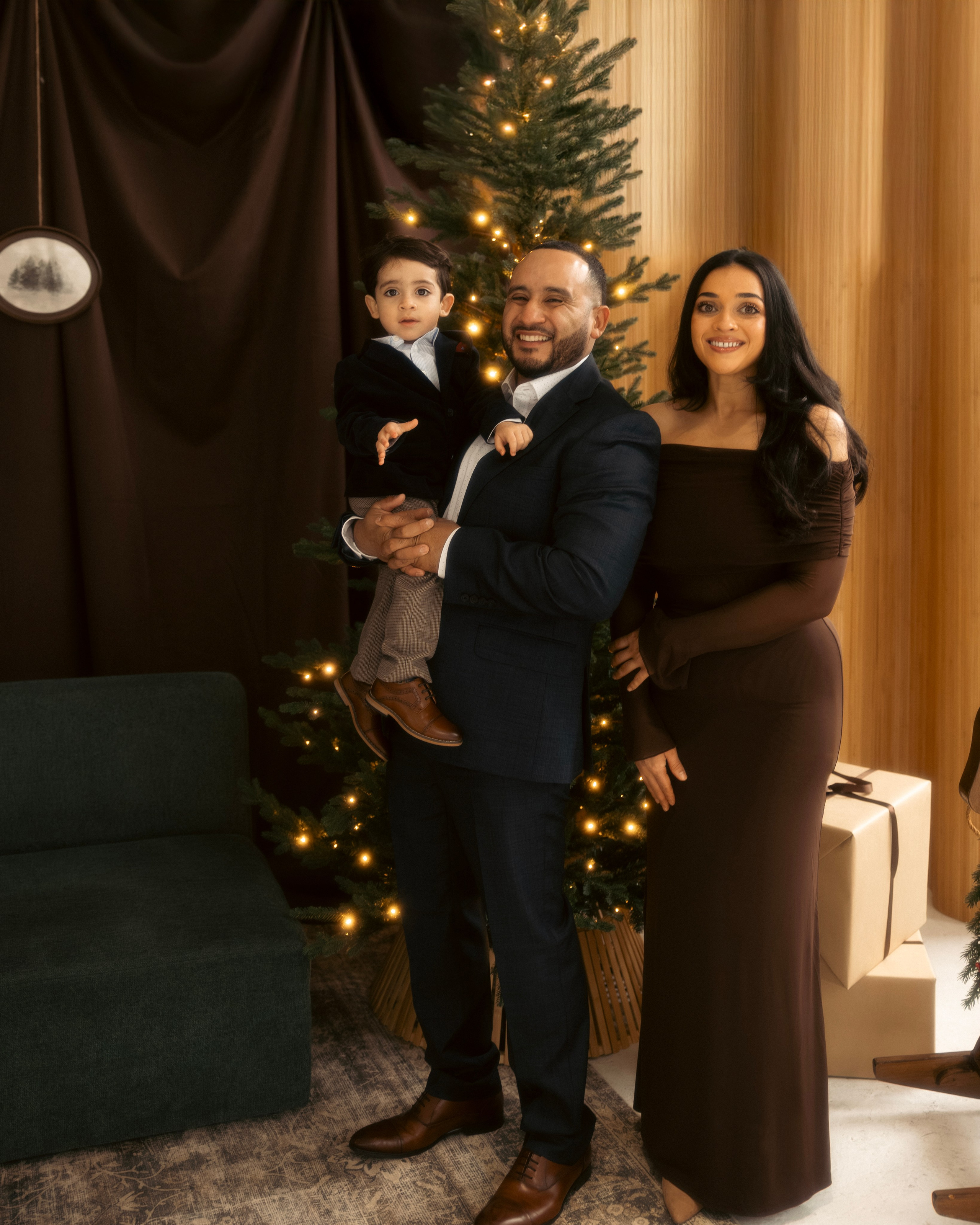 Family Christmas mini session in Chicago studio with warm lights and tree