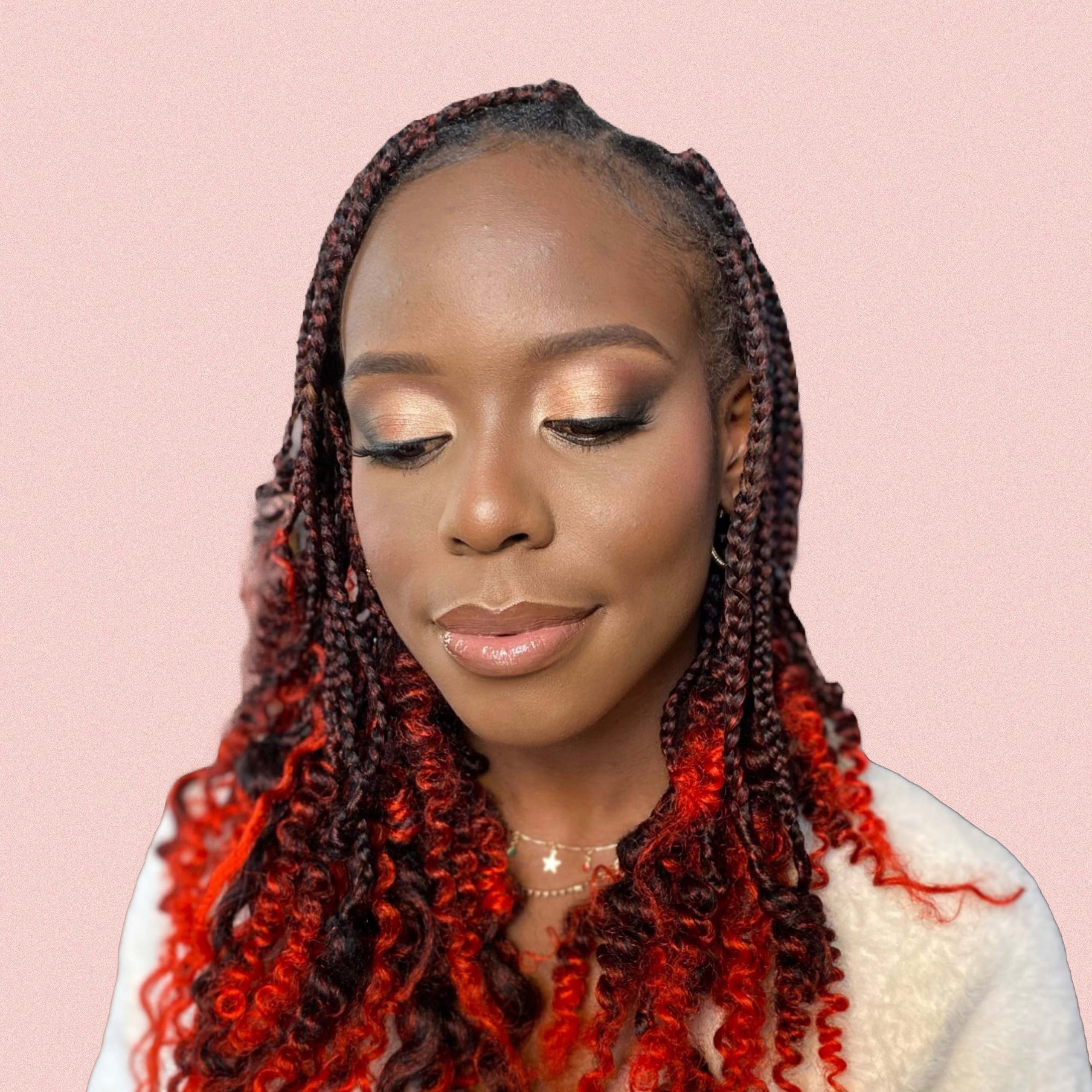 a black girl with romantic pinkish makeup and contoured nose with red locks. 