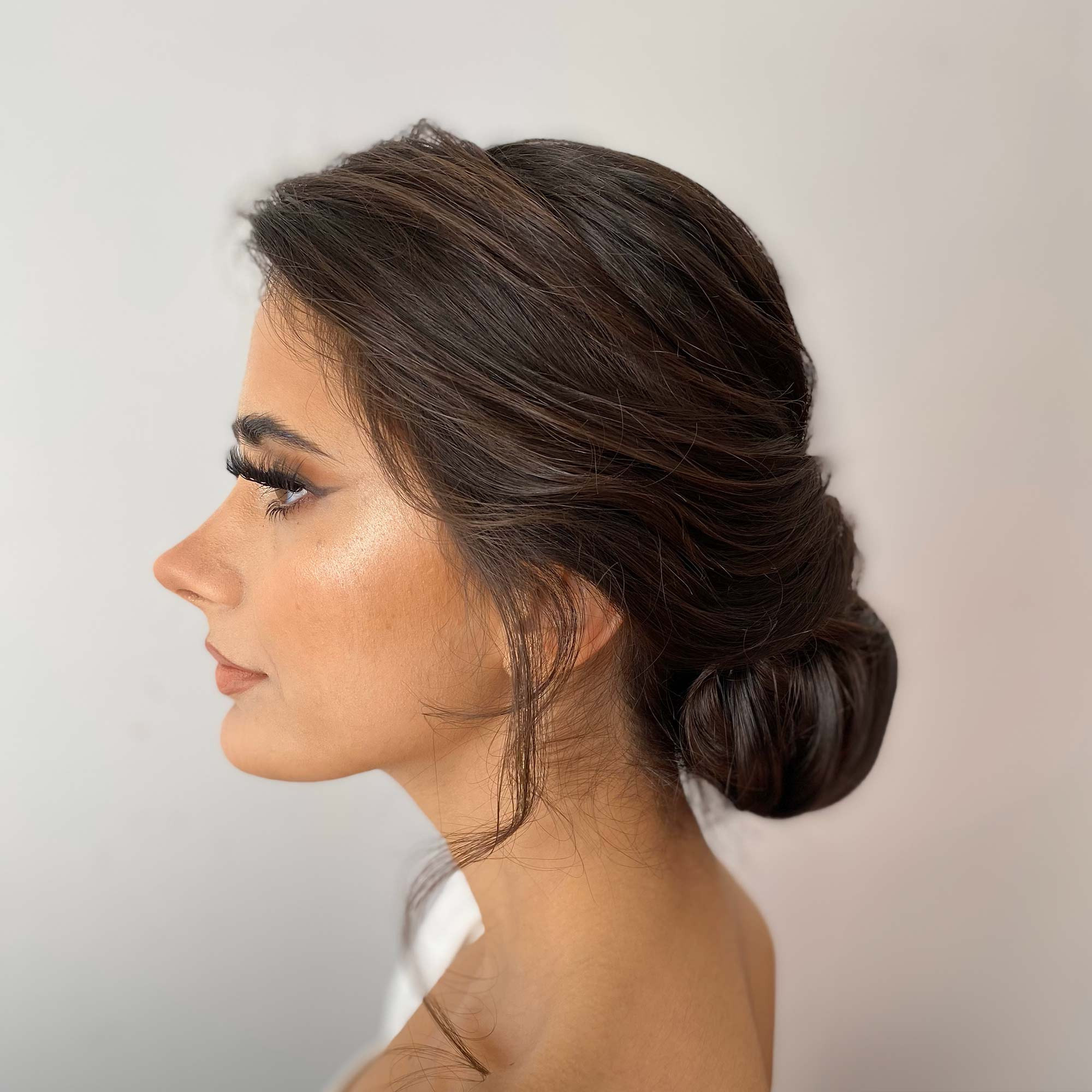 up-do hairstyle on a cute girl profile with long eyelashes