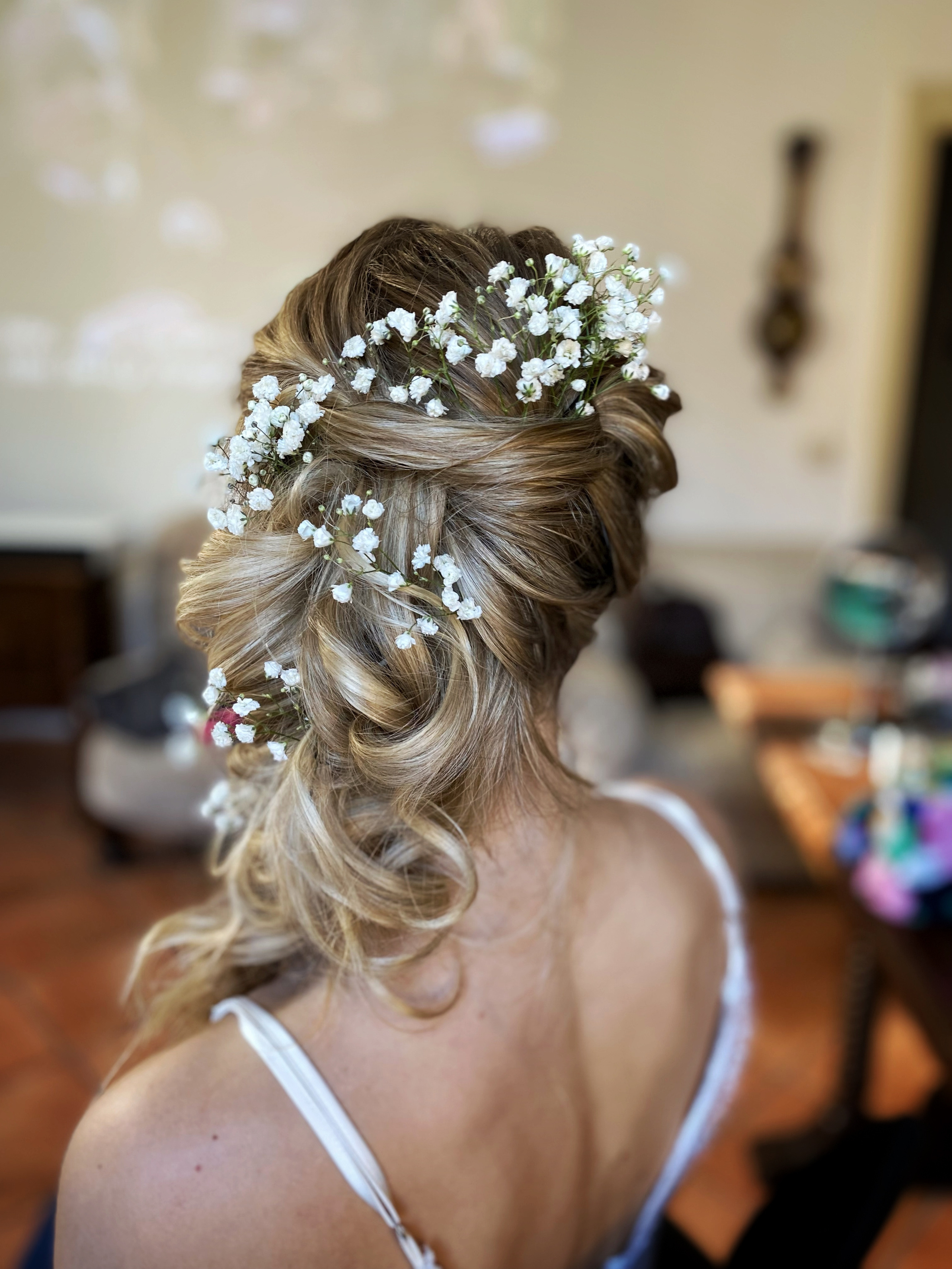 greek styled hair with natural flowers in the hairstyle