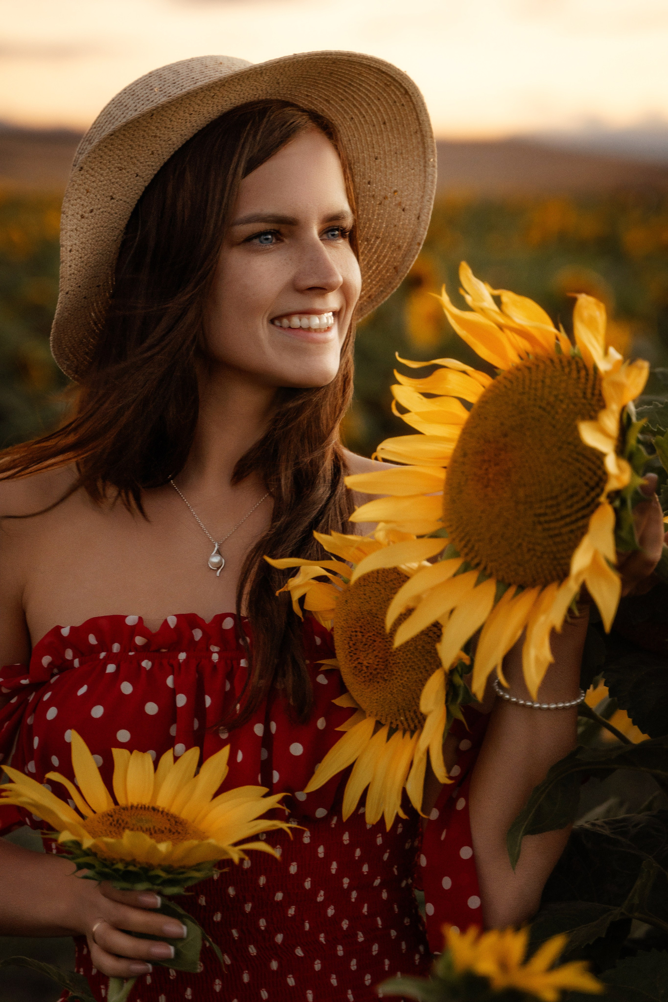 Beautiful woman in sunflower field at sunset, captured by portrait photographer in Marbella
