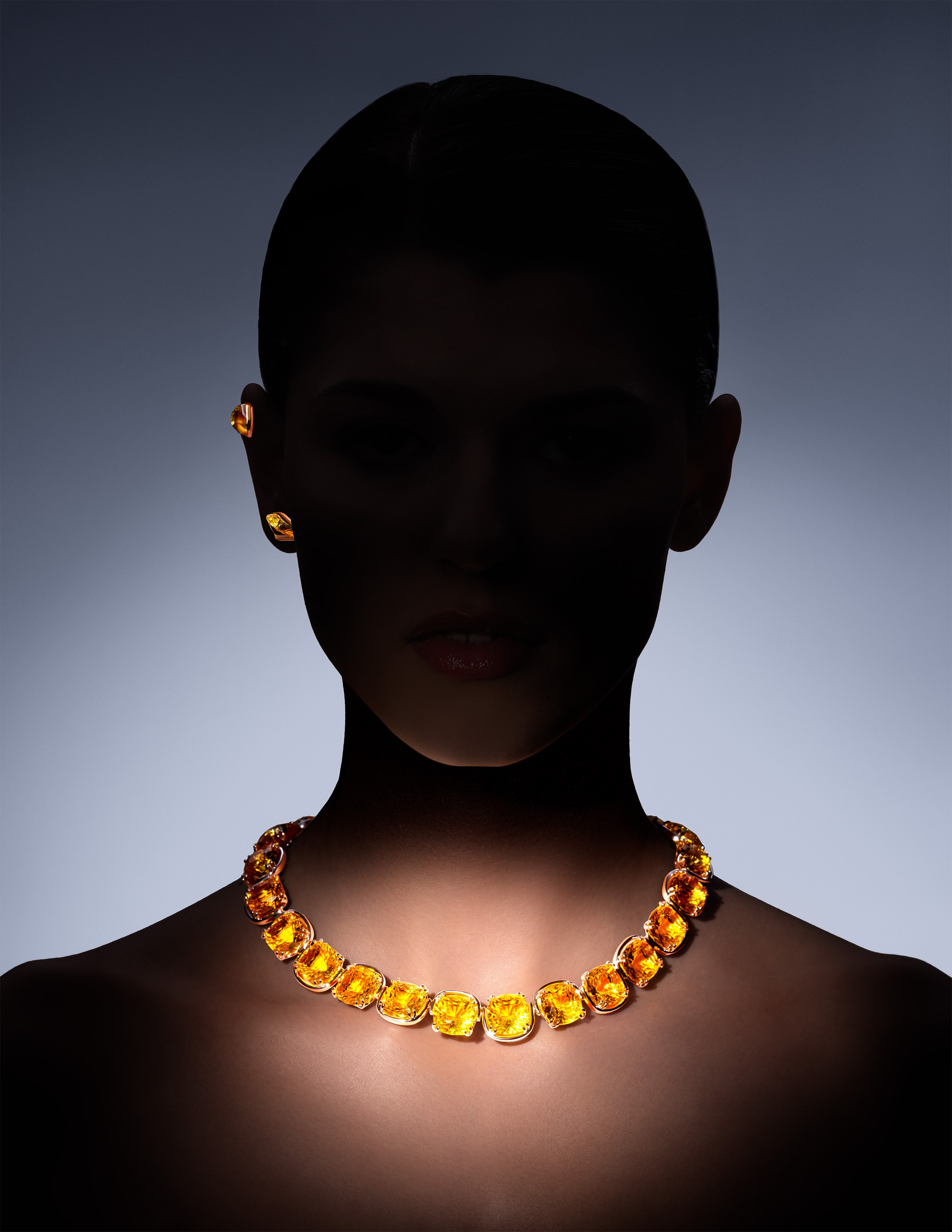 Swarovski statement necklace and matching earrings in warm yellow gemstones, highlighted by artistic lighting for a high-end fashion campaign.