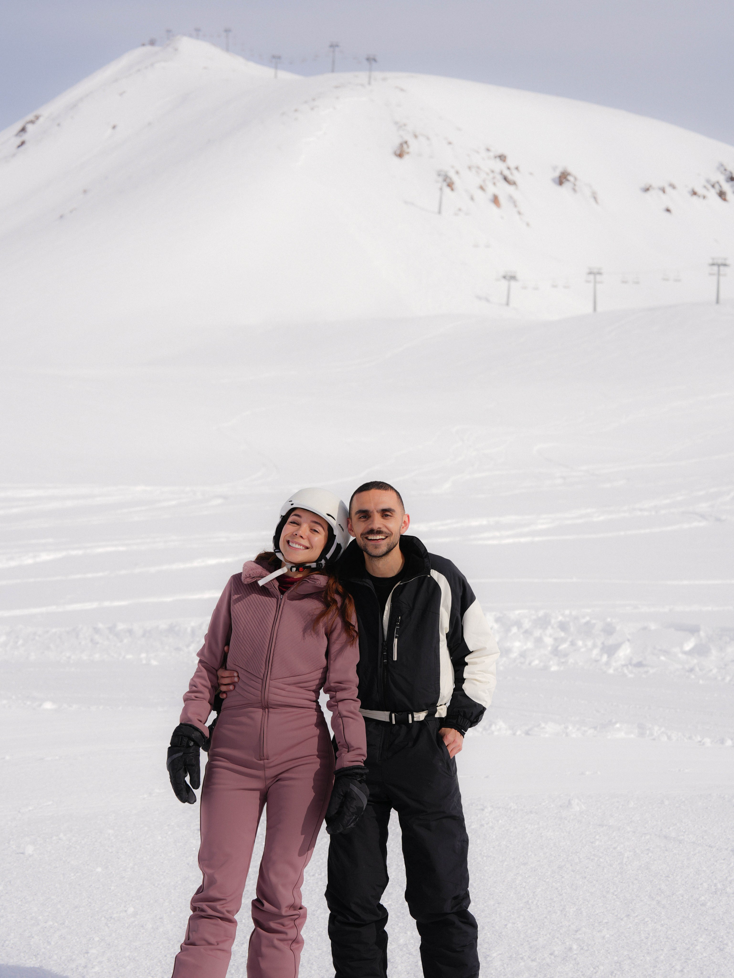 Couple standing on ski slope in Gudauri winter