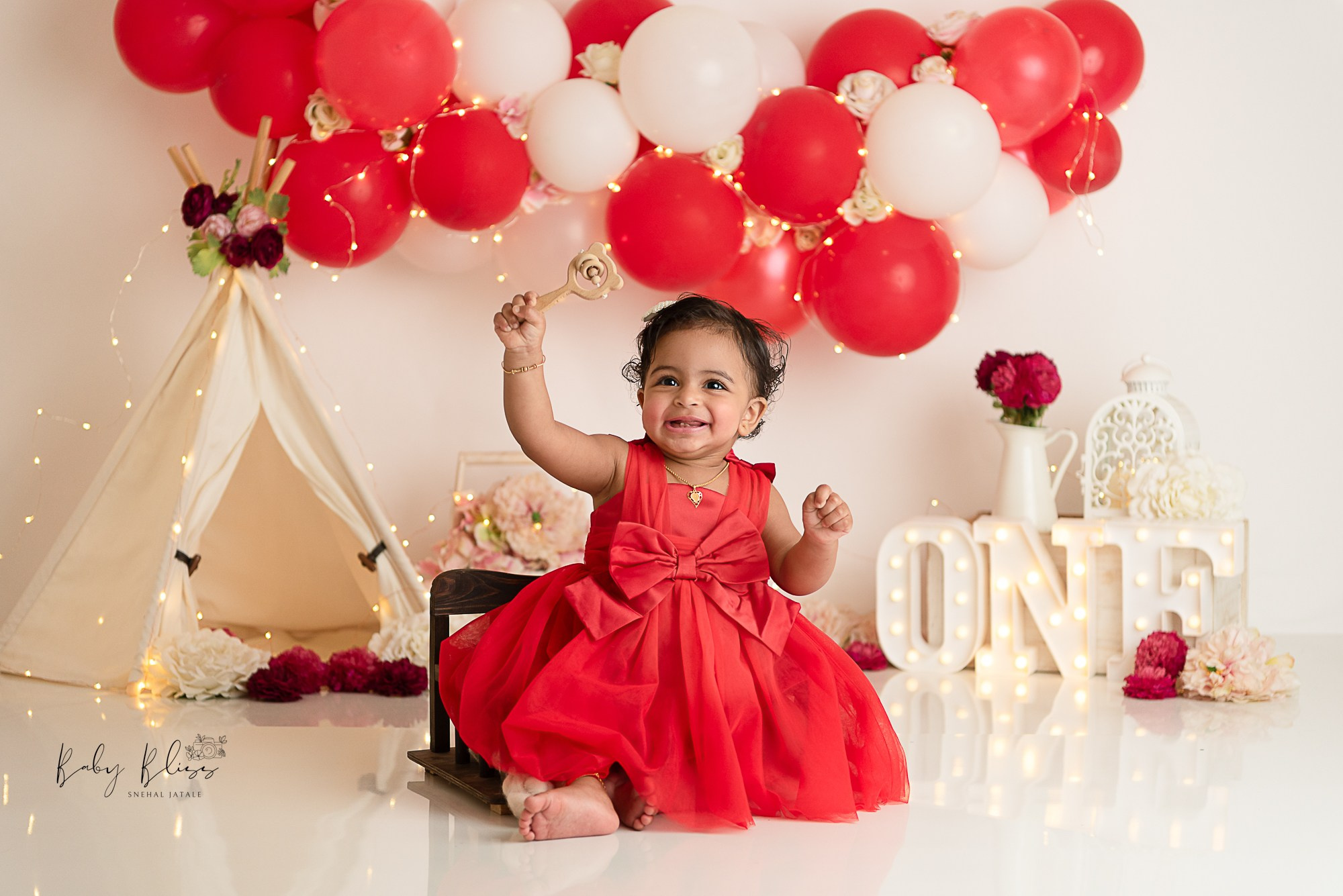 red and beige colour cake smash setup for little girl in Doha Qatar