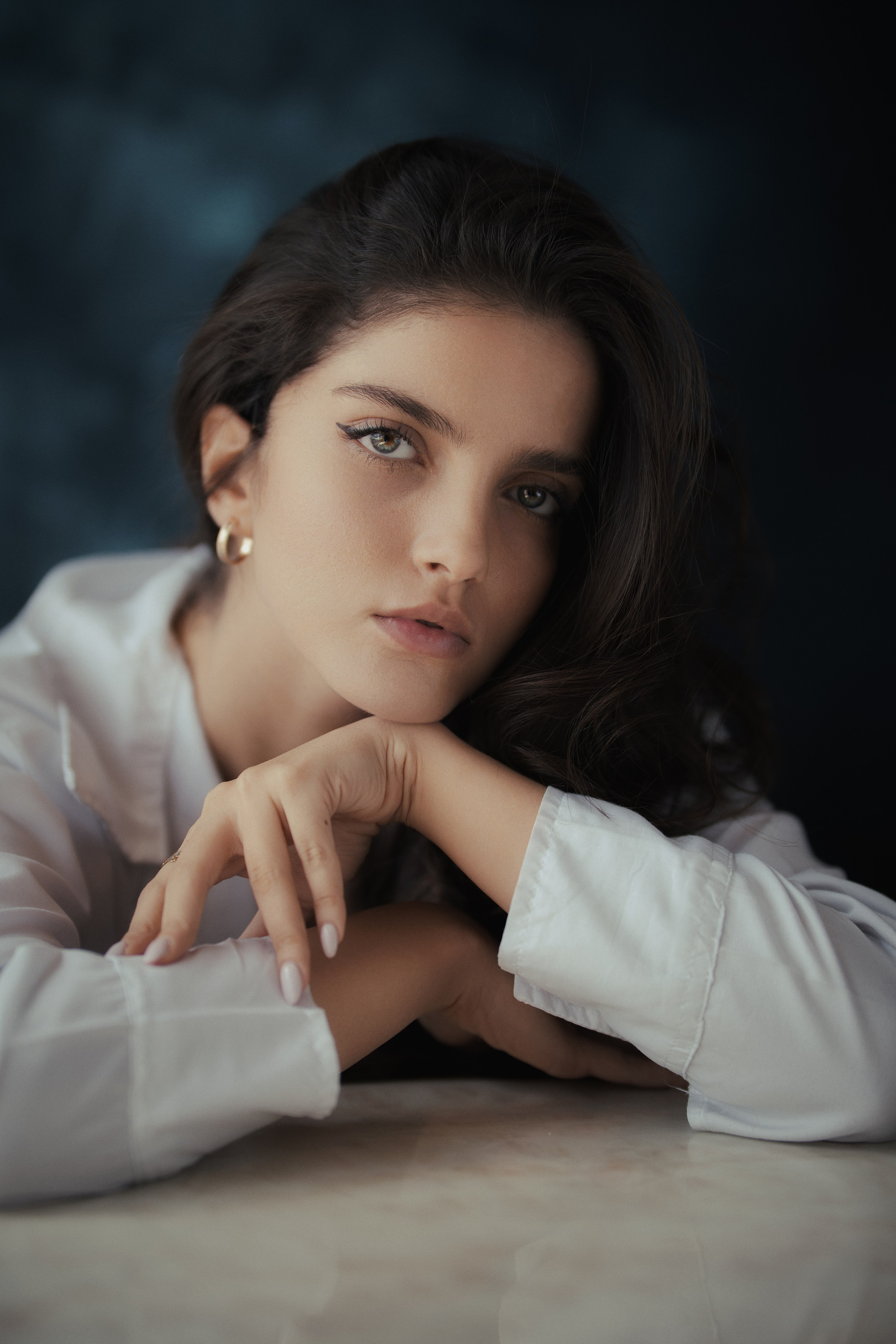 Cinematic female portrait by Mehran Hadad featuring a young woman with natural makeup, soft studio lighting, and an elegant fine art portrait style.