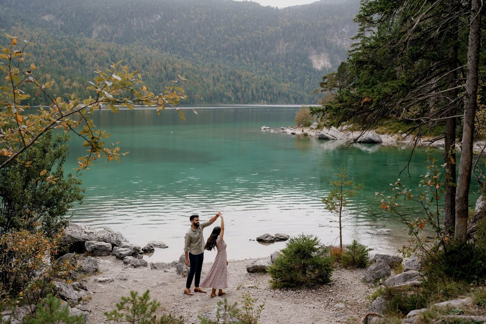 Wide landscape of Eibsee lake with mountains - couple visible in the distance, Bavaria Germany
