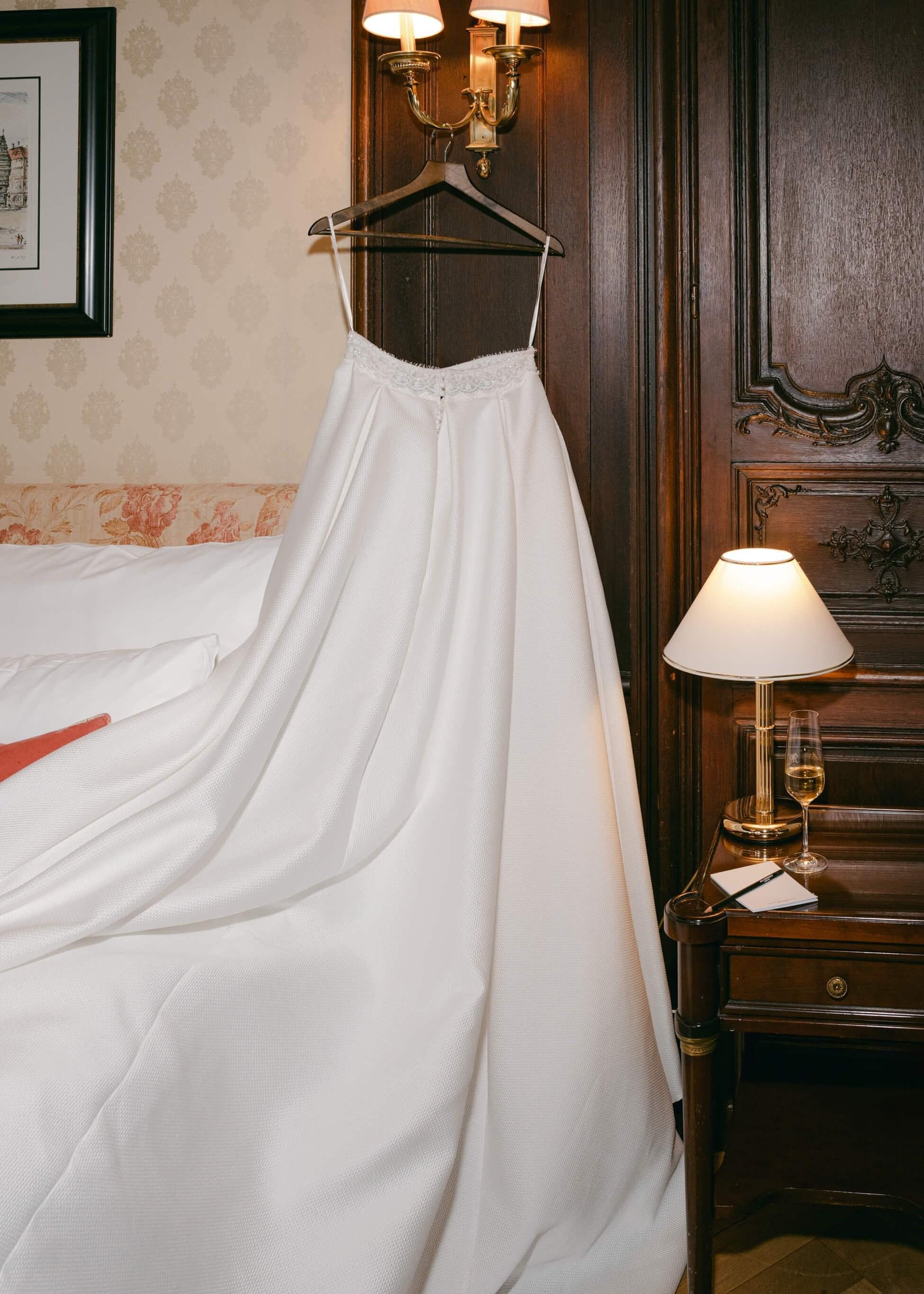 White lace wedding dress hanging in luxury suite at Villa Rothschild Frankfurt