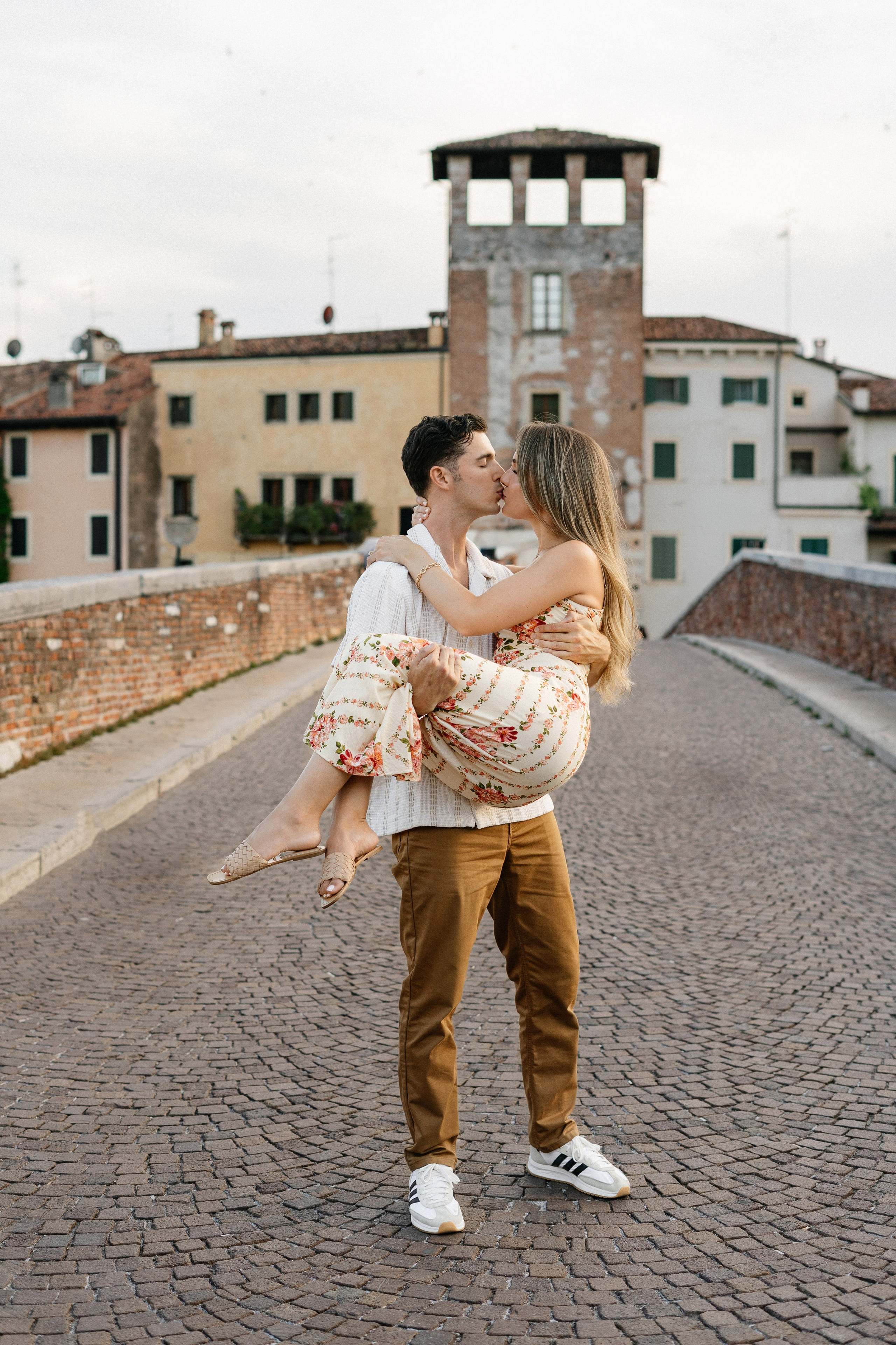 Romantic portrait of an engaged couple in the Ponte Pietra district of Verona