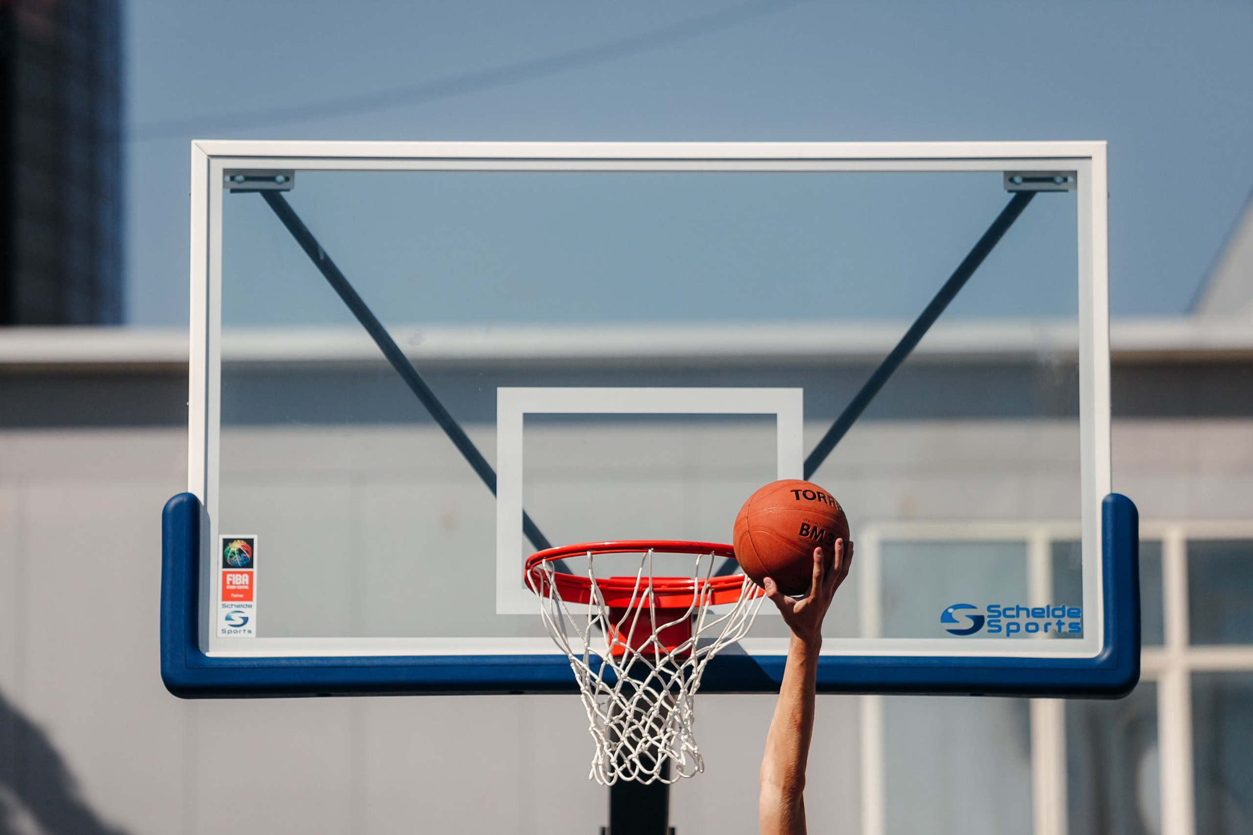 Basketball player dunking ball into hoop