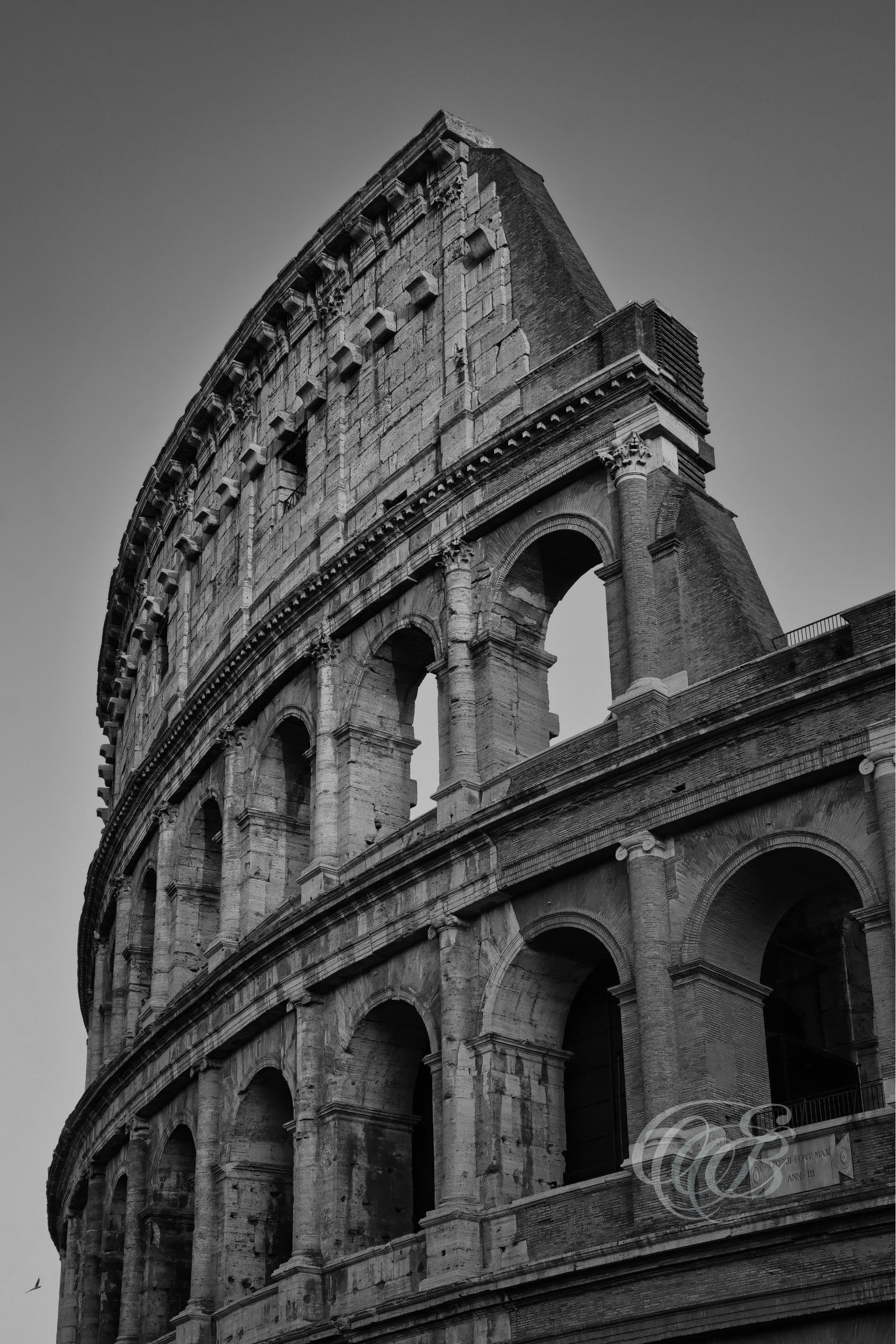 Rome, Italy – The Colosseum in the late afternoon – B&W – Eduardo Bartoli Fine Art Photography – Black and white photograph of the Colosseum’s eastern façade in late afternoon light, highlighting travertine arches and deep shadows.