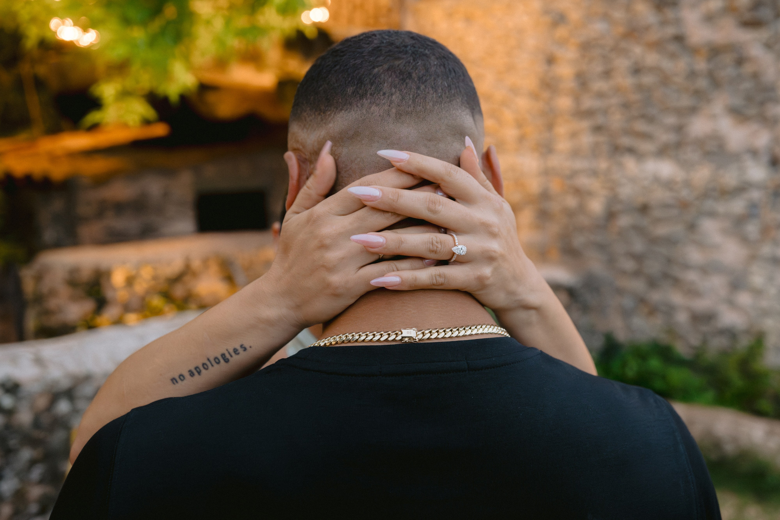 Man proposing to a woman at a scenic overlook with a river valley in the background, surrounded by rustic stone of Altos de chavon. Punta cana wedding family fashion photographer dominican republic, destination wedding photographer, elopement photography Punta Cana