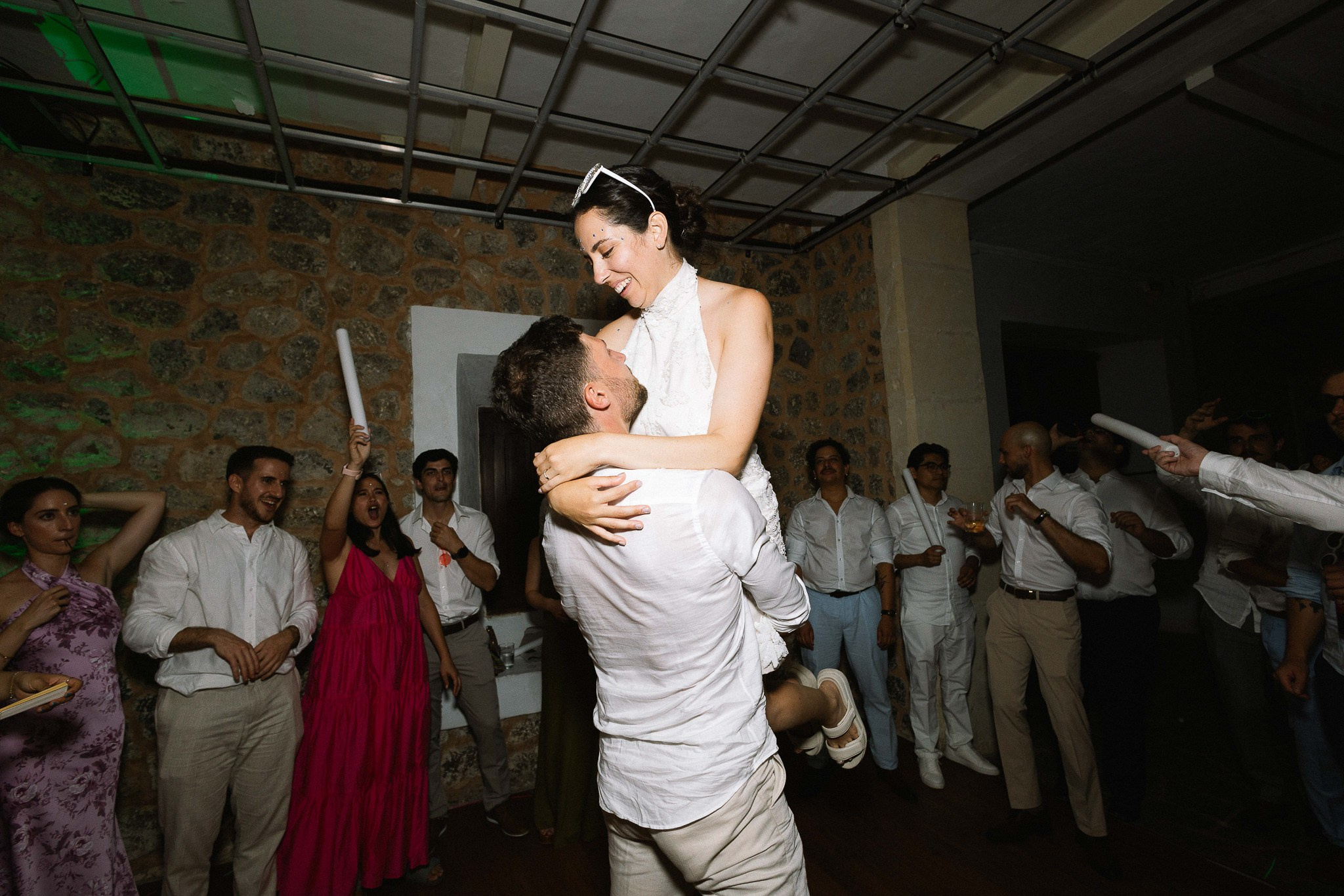Bride lifted into groom's arms on the dance floor, joyful wedding reception moment at Son Marroig, Mallorca
