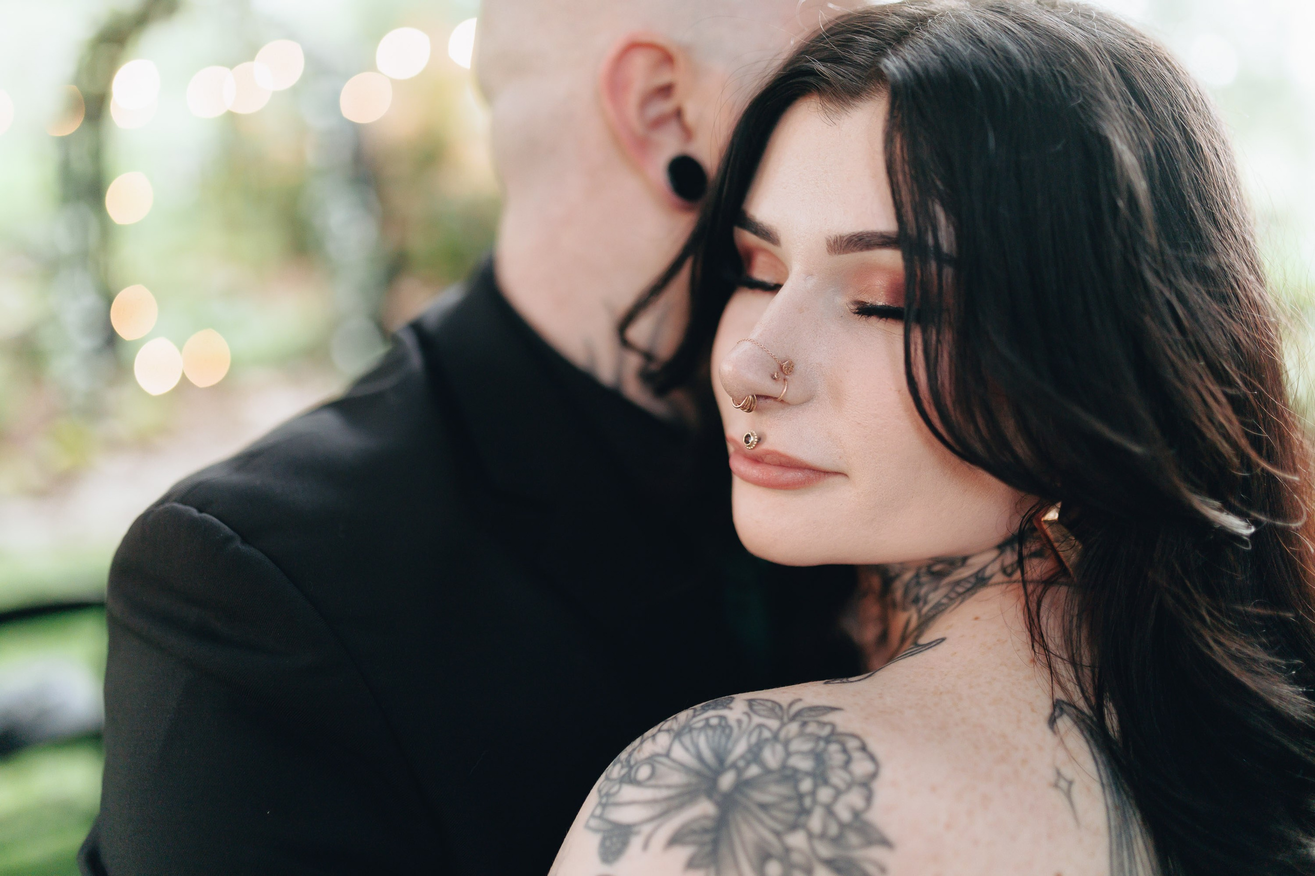 Tattooed couple embracing, alternative wedding style