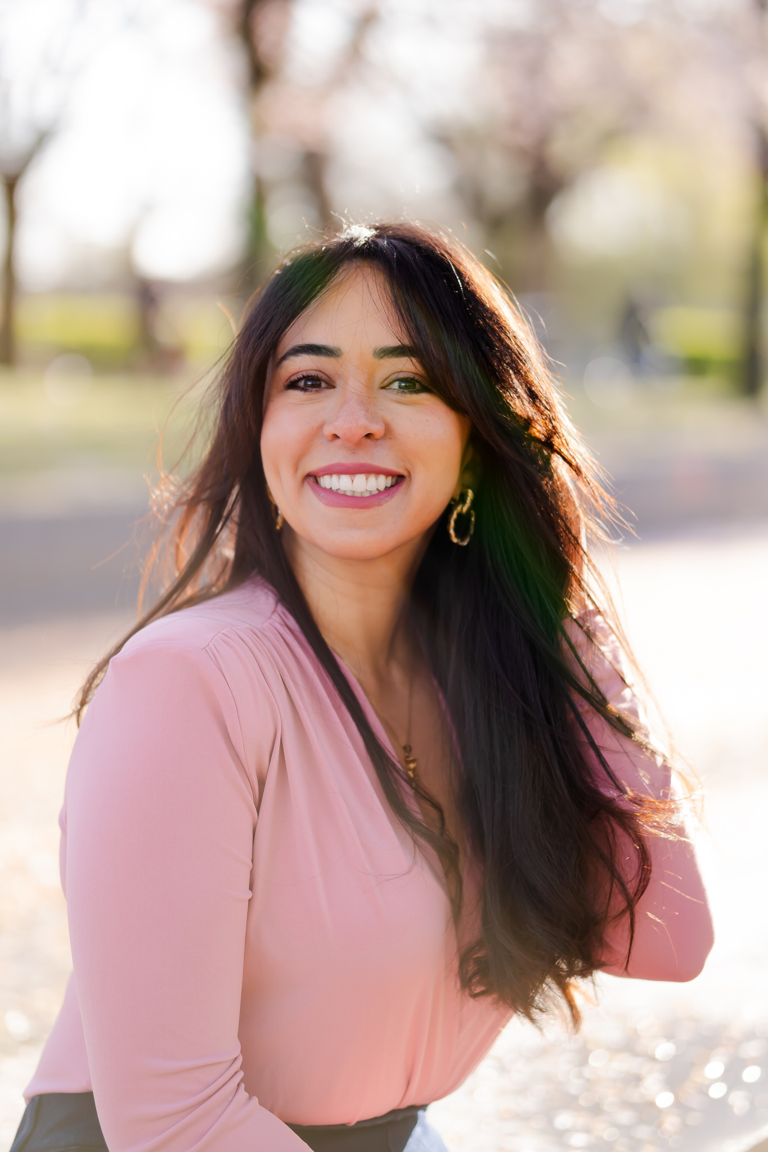 girl smiling in a cherry blossoms garden