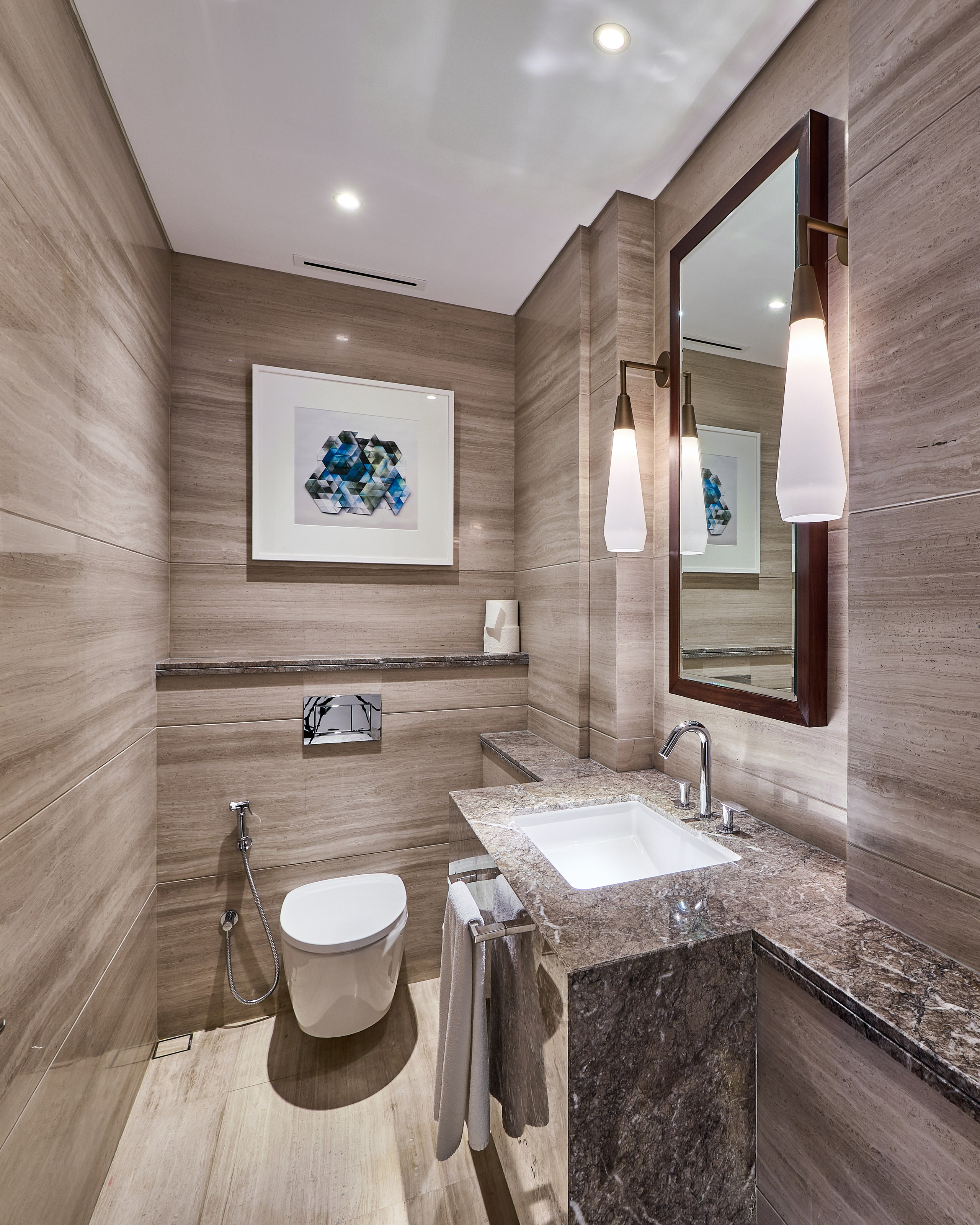 Elegant powder room in a luxury penthouse near Burj Khalifa, with stone textures and contemporary lighting. Interior photo by Dubai property photographer Oleg Novikov.