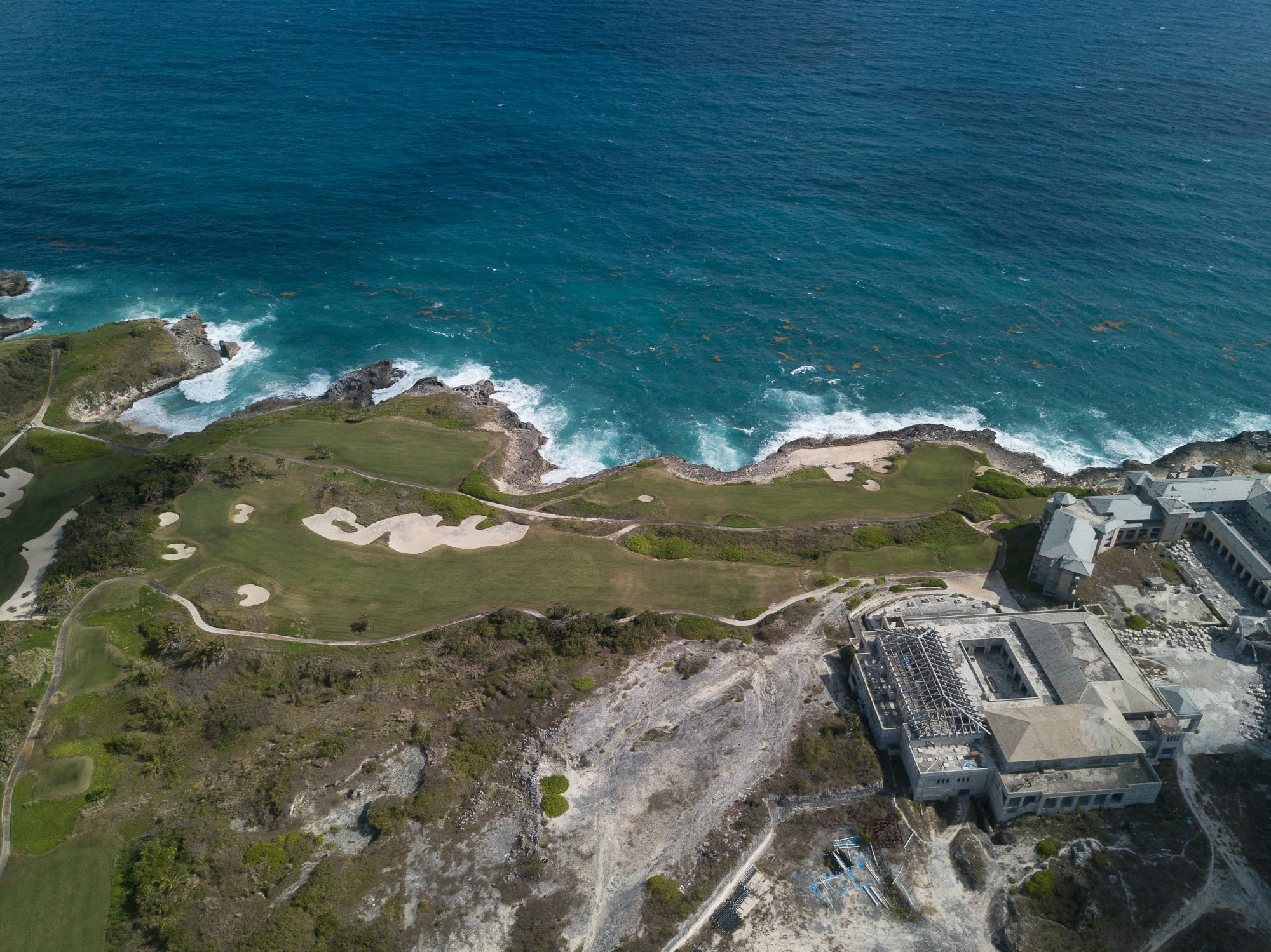Abandoned hotel ruins near Macao Beach surrounded by tropical vegetation in Punta Cana.