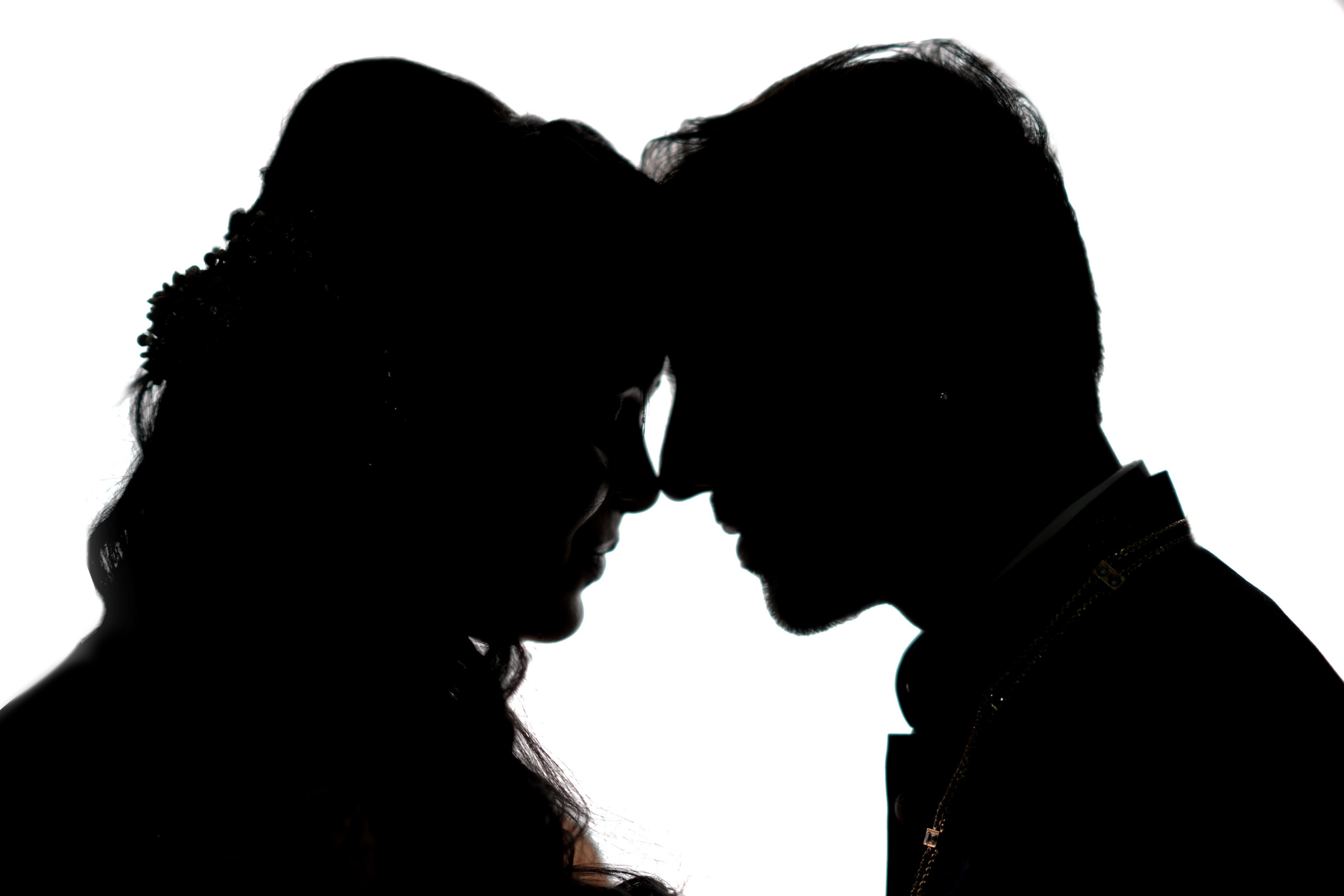  romantic studio silhouette portrait of a bride and groom touching foreheads during a photoshoot in Malleshwaram, Bengaluru