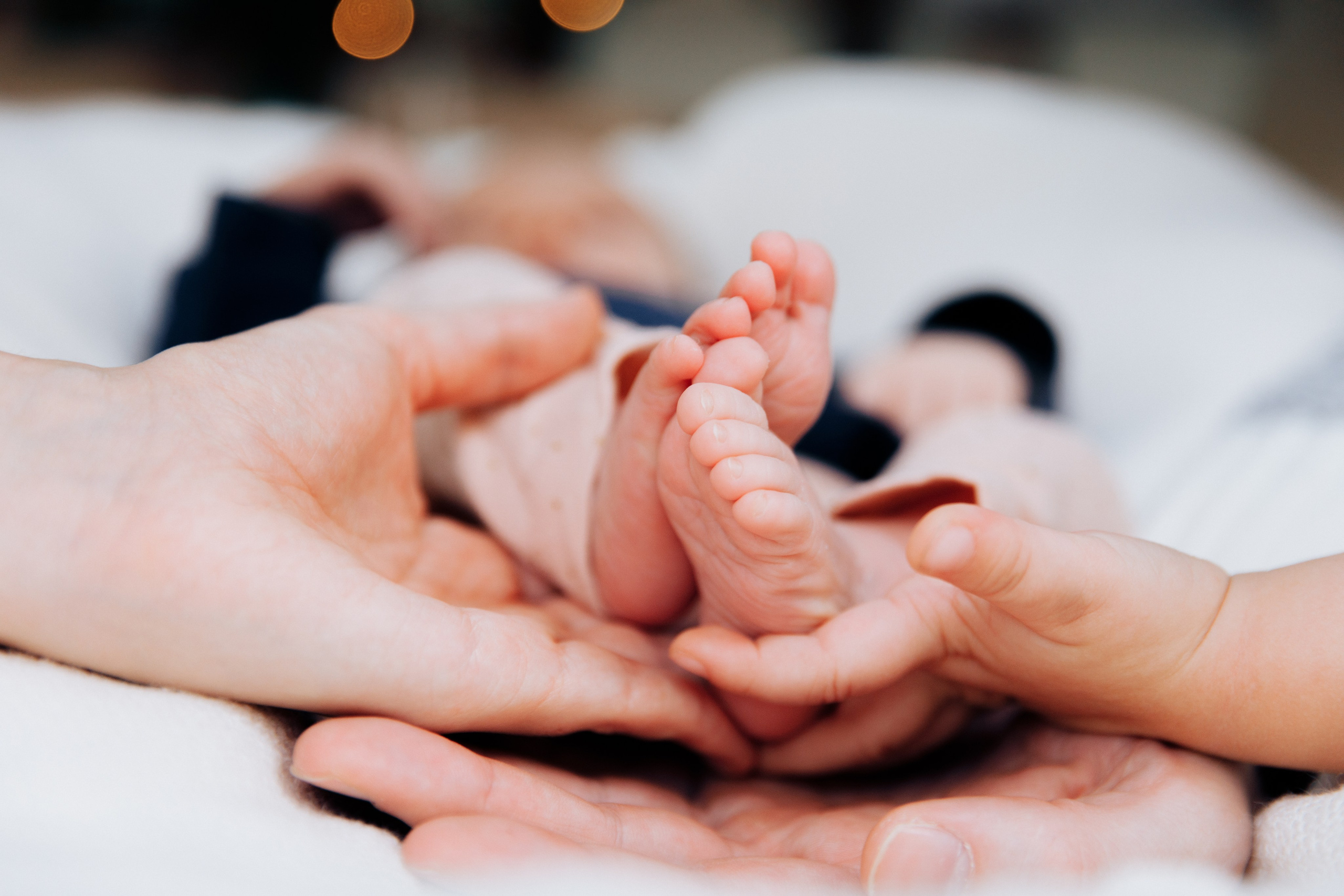 Neugeborenes liegt zart auf dem Arm seines Vaters während eines liebevollen Newborn-Fotoshootings.
