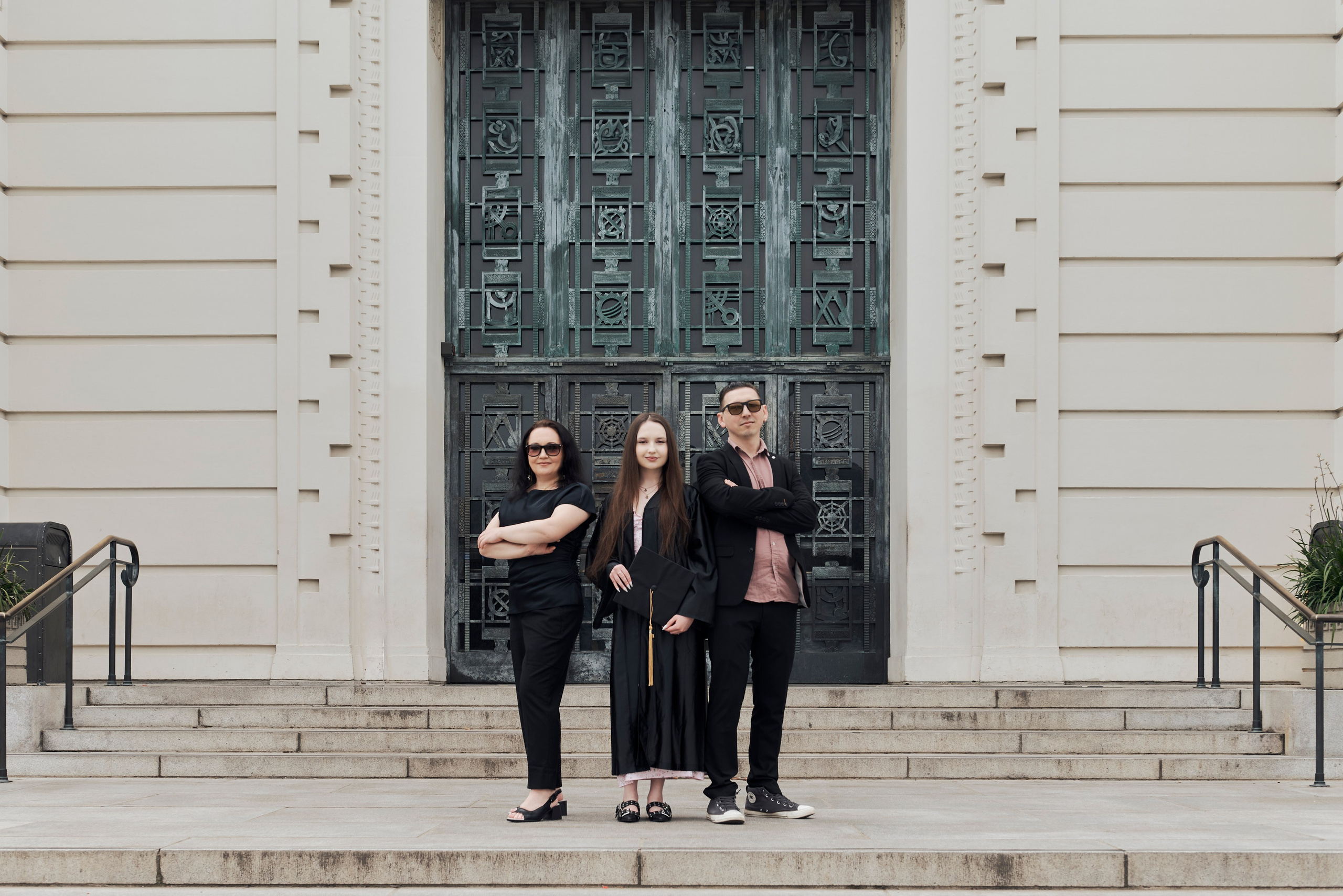 Graduate with proud parents at a Los Angeles graduation photo shoot