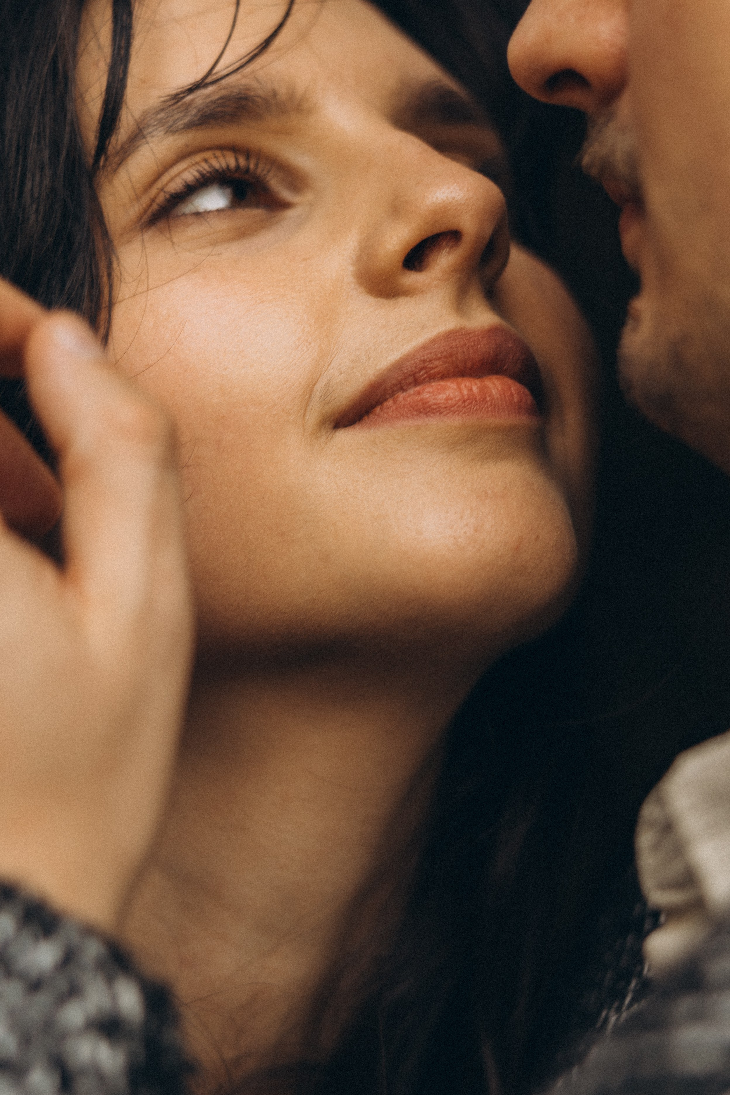 Couple holding hands and walking through a picturesque coastline in Portugal.