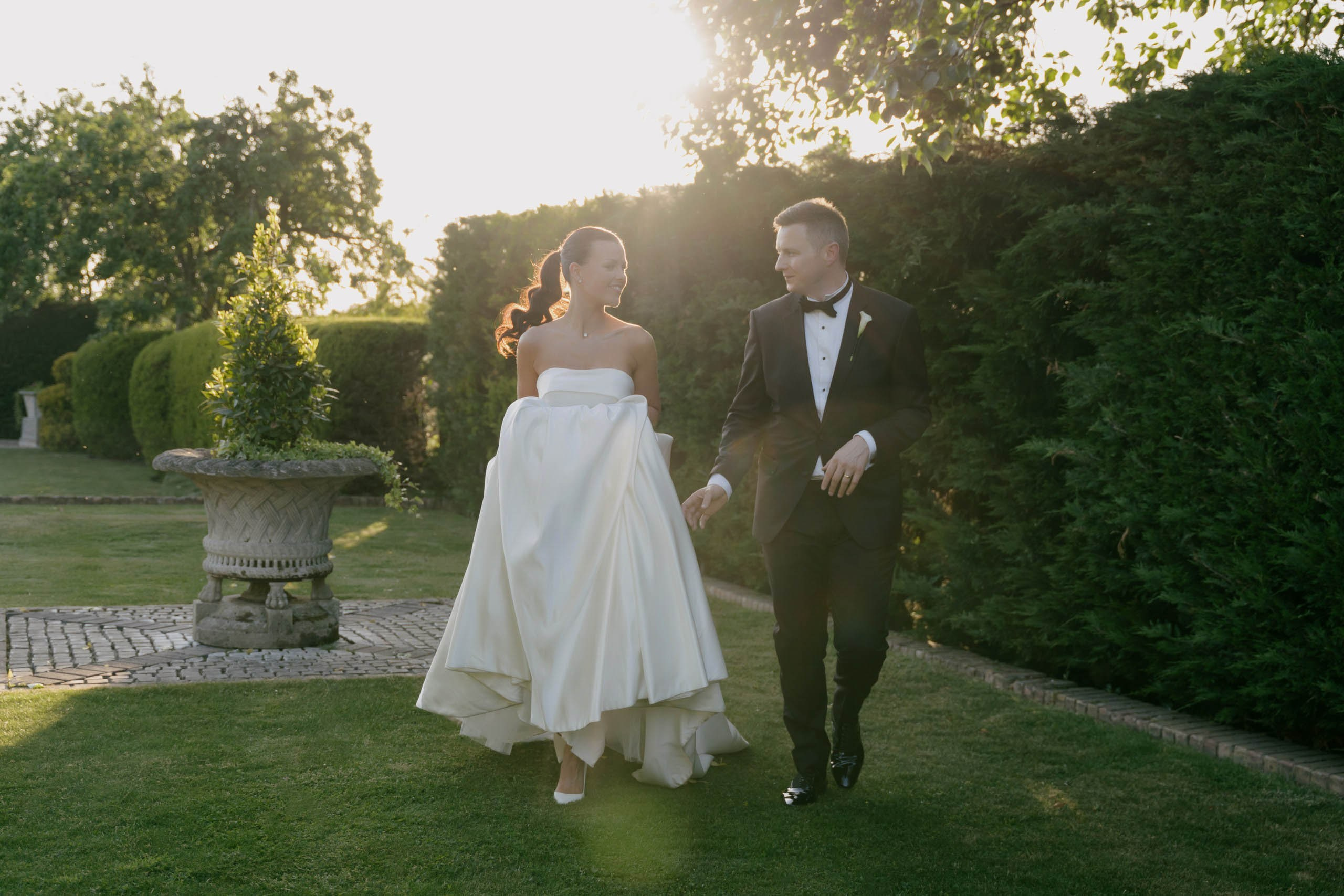 Bride and groom walking together garden wedding Friern Manor Essex