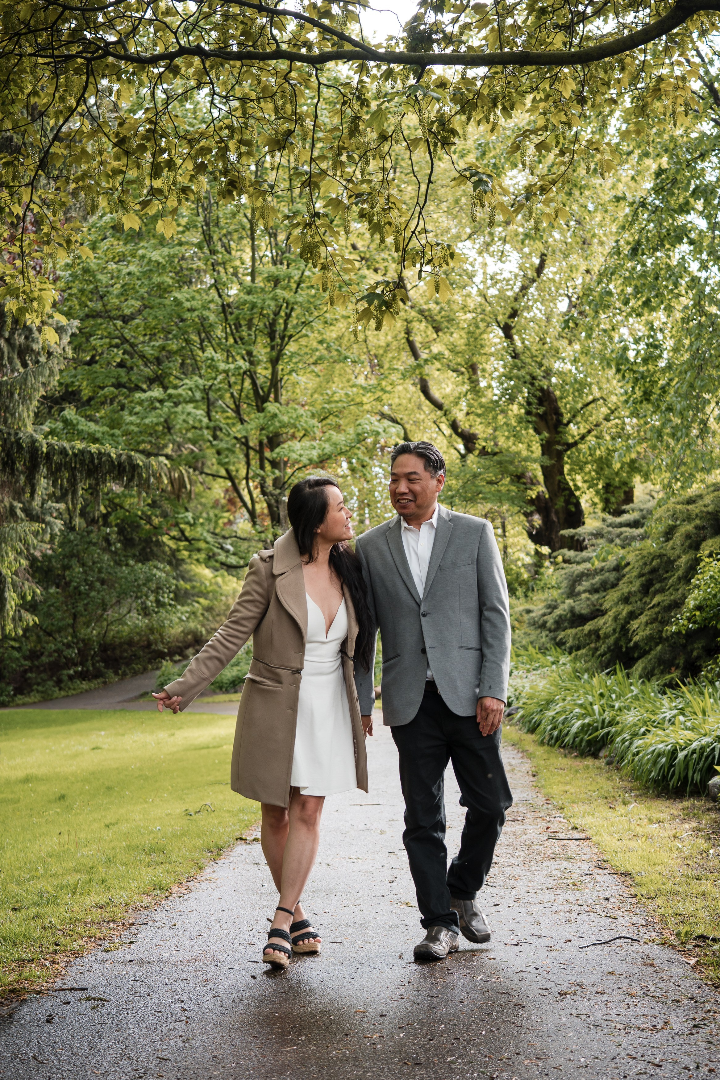 Engaged couple hugging in a forest during a romantic photoshoot