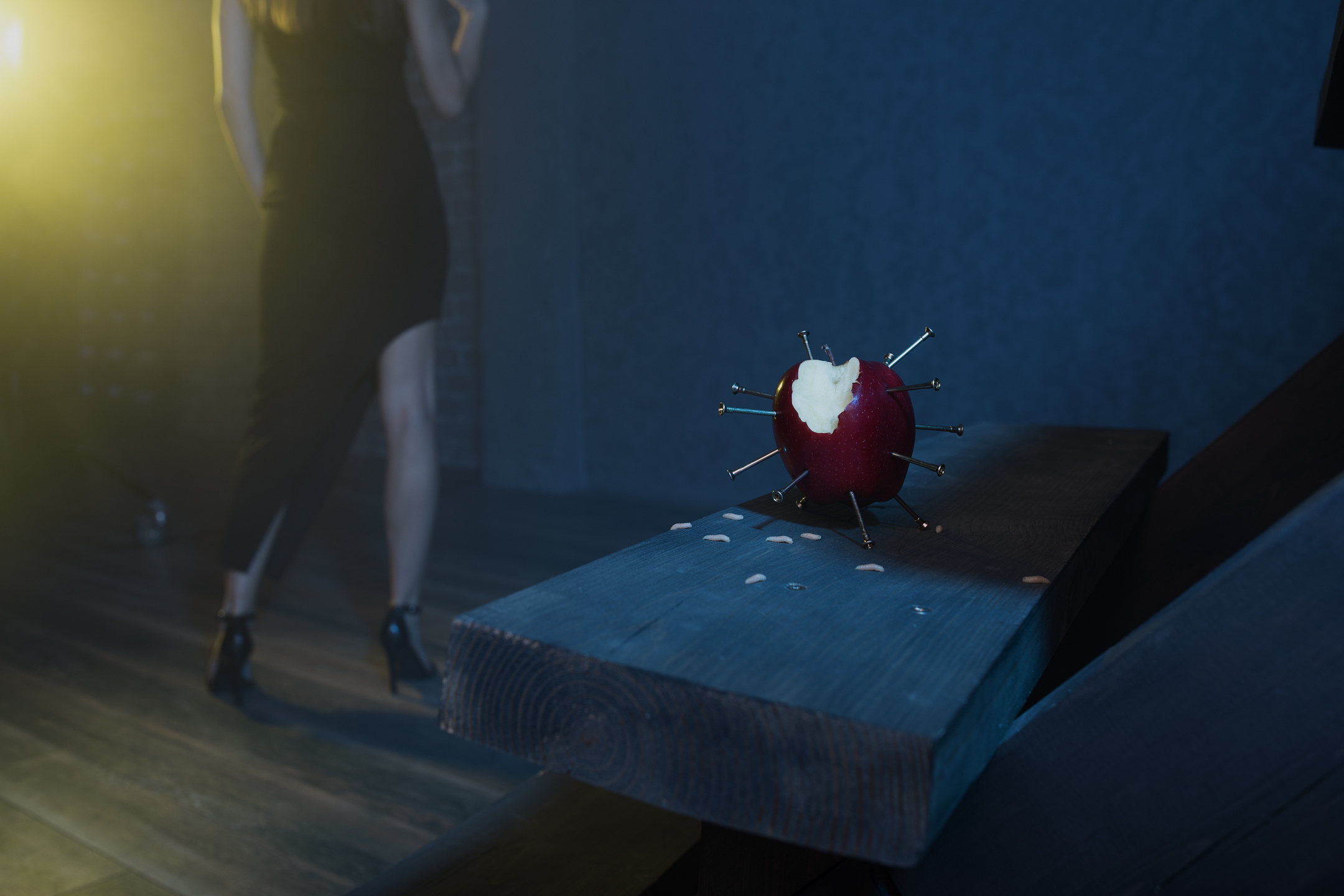 Still life of bitten apple with nails — conceptual detail from Modern Eve series