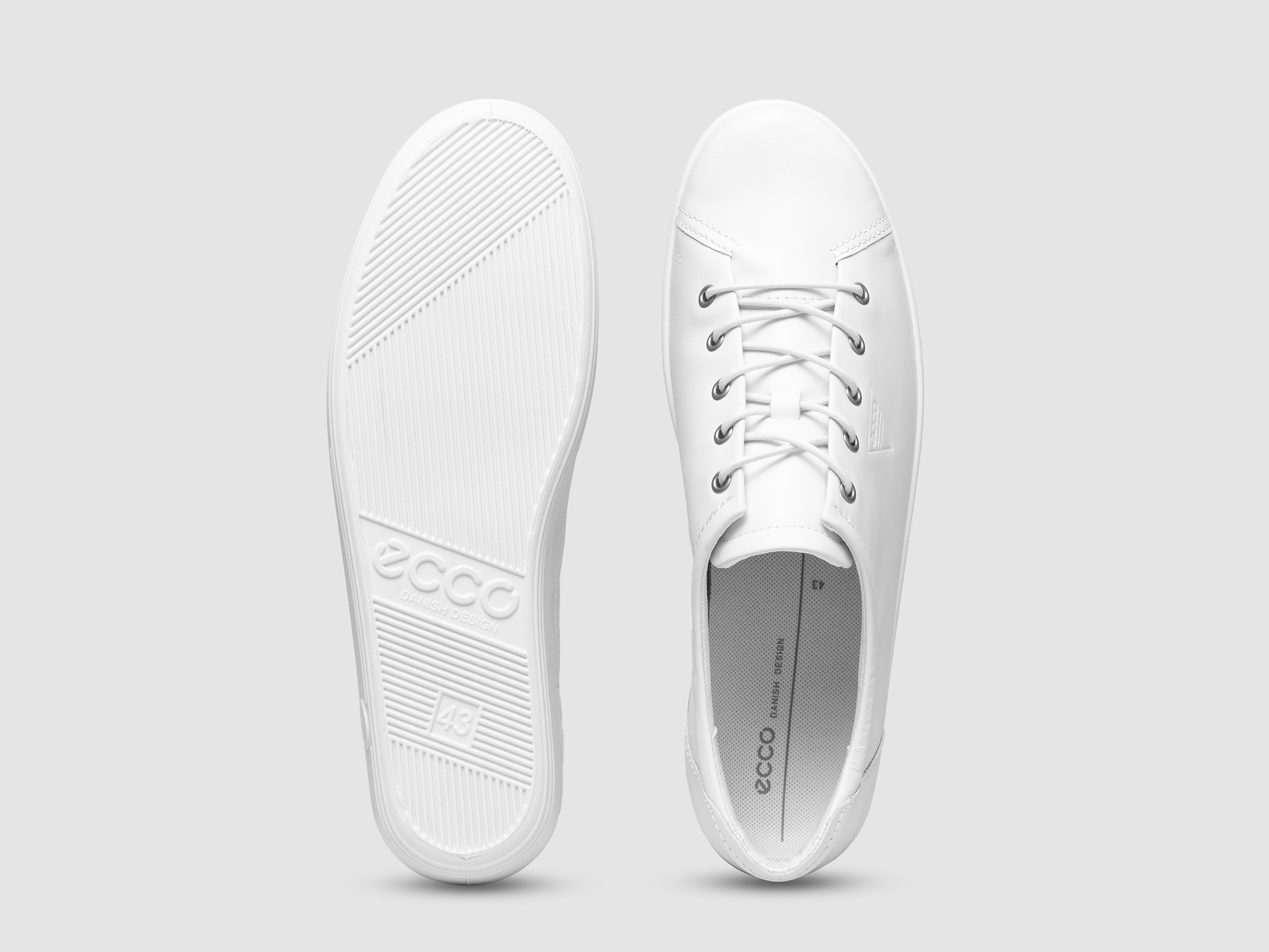 White sneakers top sole view white background footwear product photography