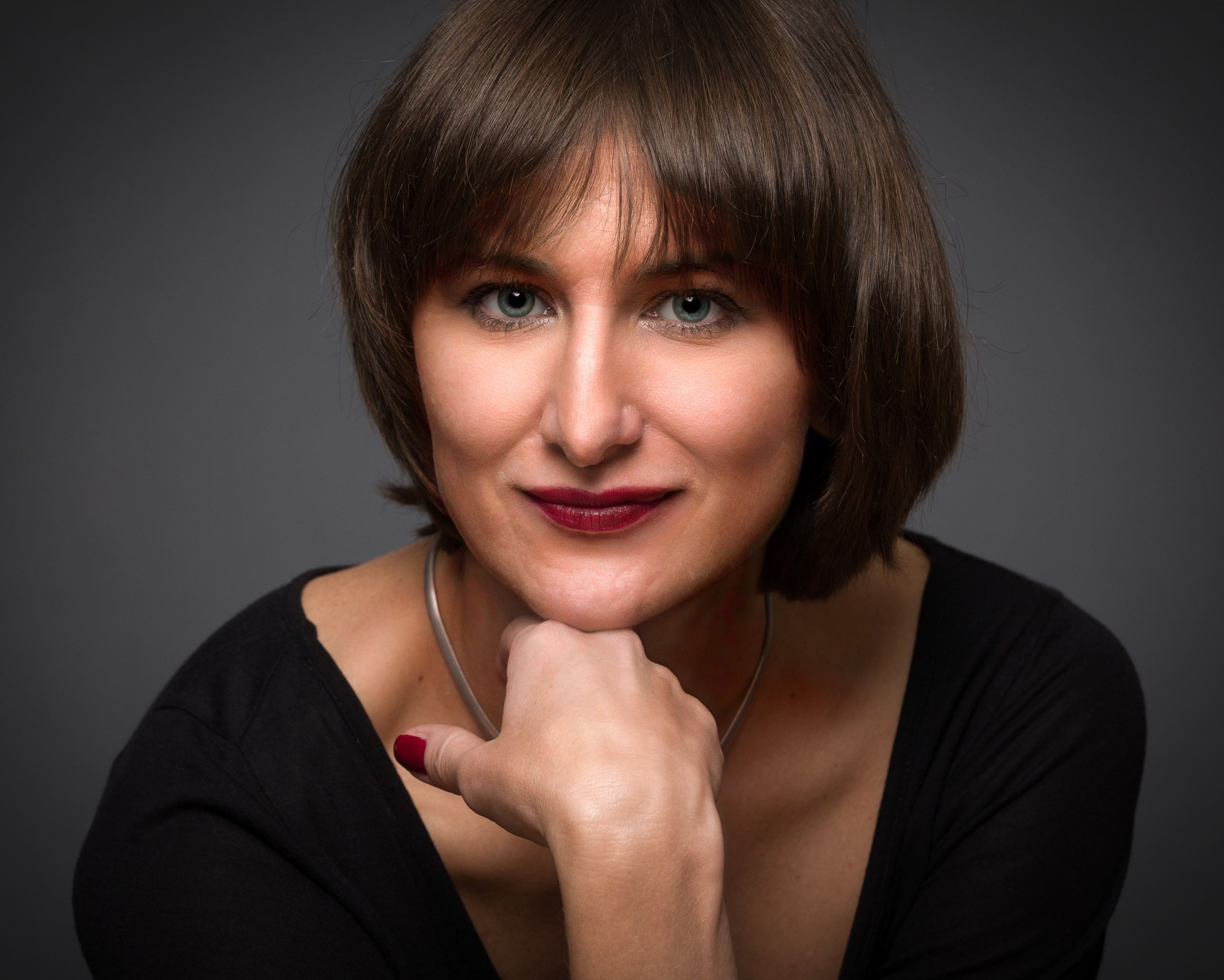 Portrait of a young lady on dark studio background - photographer Andrey Dunin