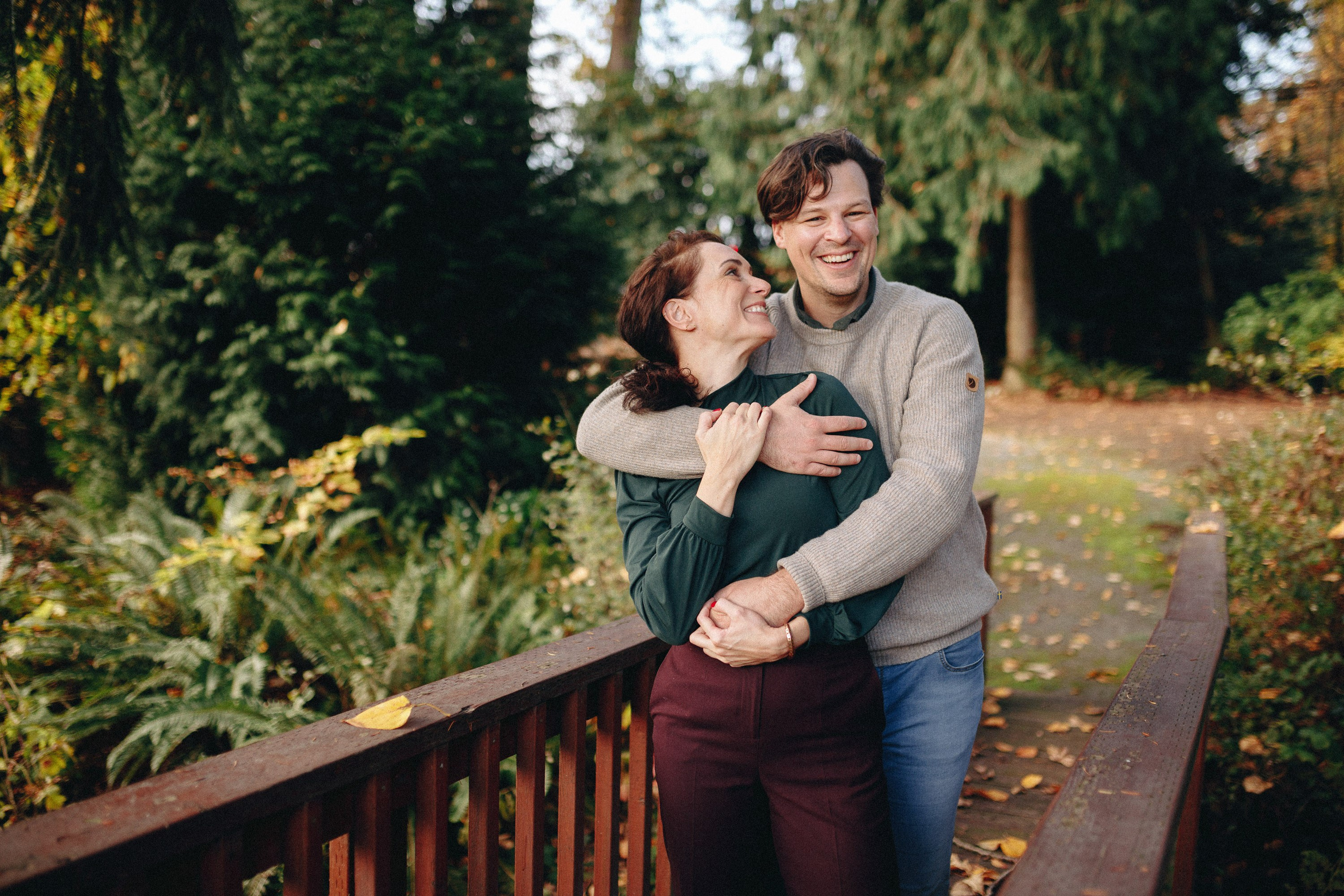 Couple hugging on wooden bridge, casual outdoor session
