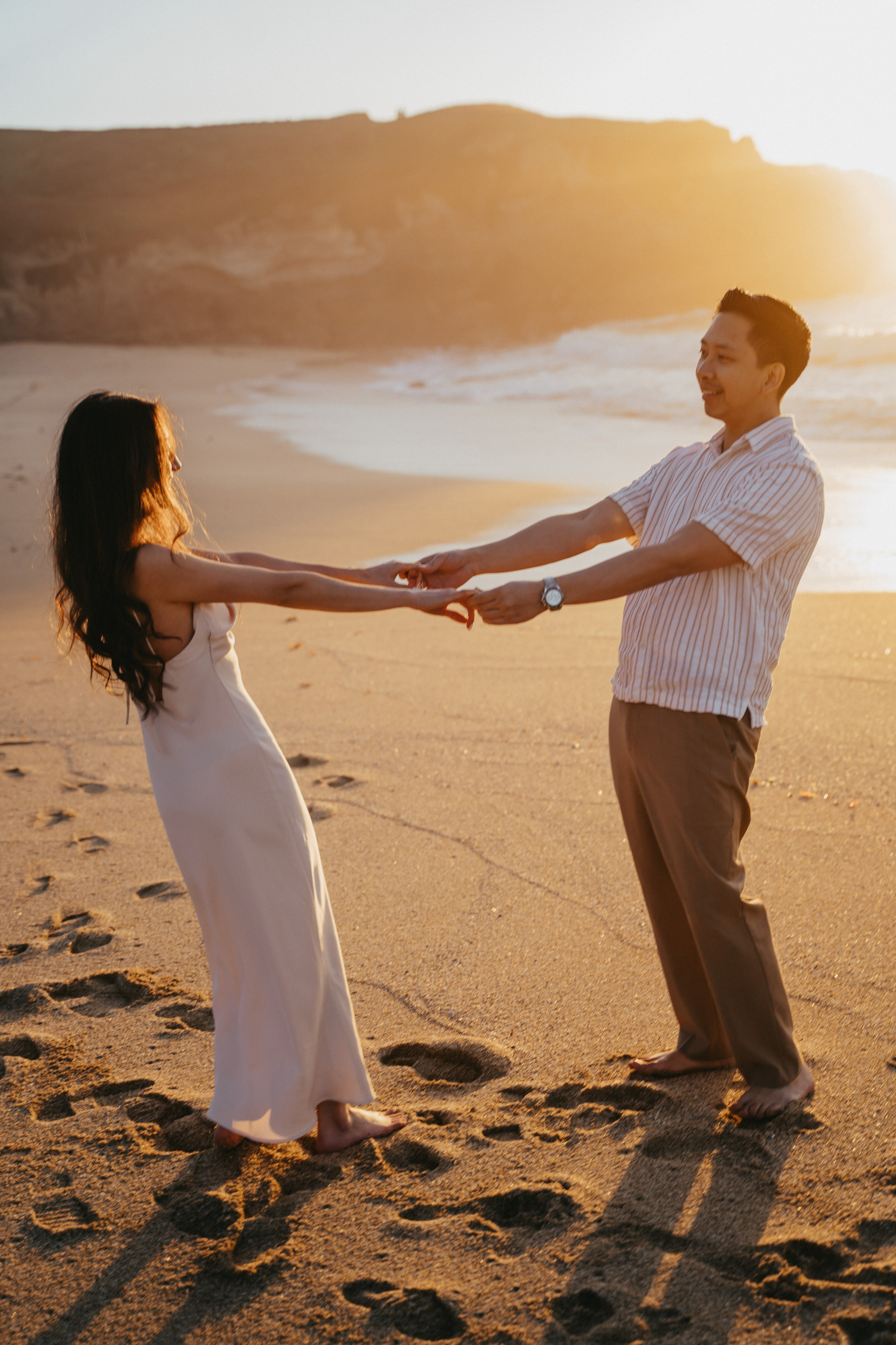 A photo shoot on the San Francisco beach at sunset. Engagement session. 