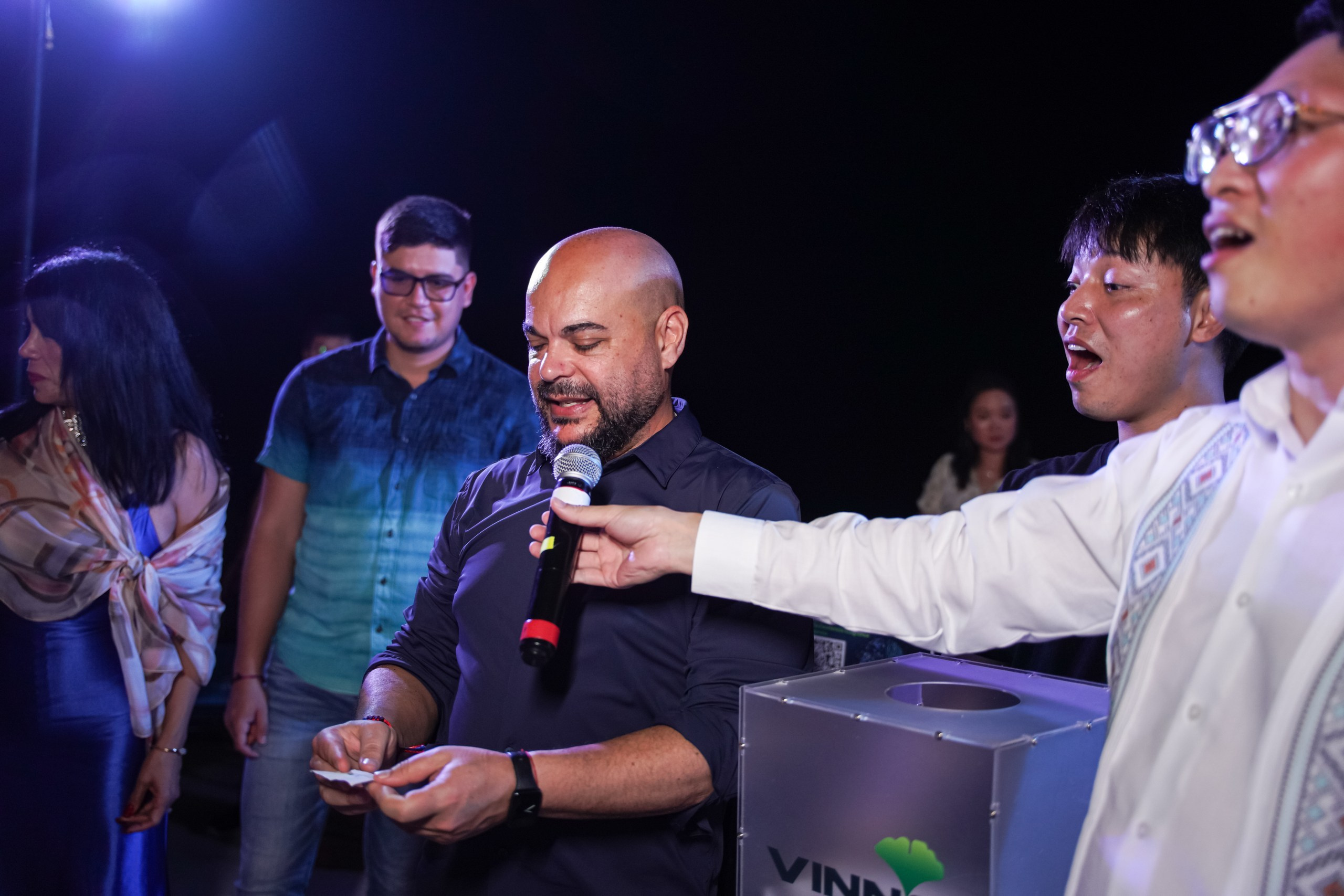 Employee receiving appreciation gift at award ceremony.