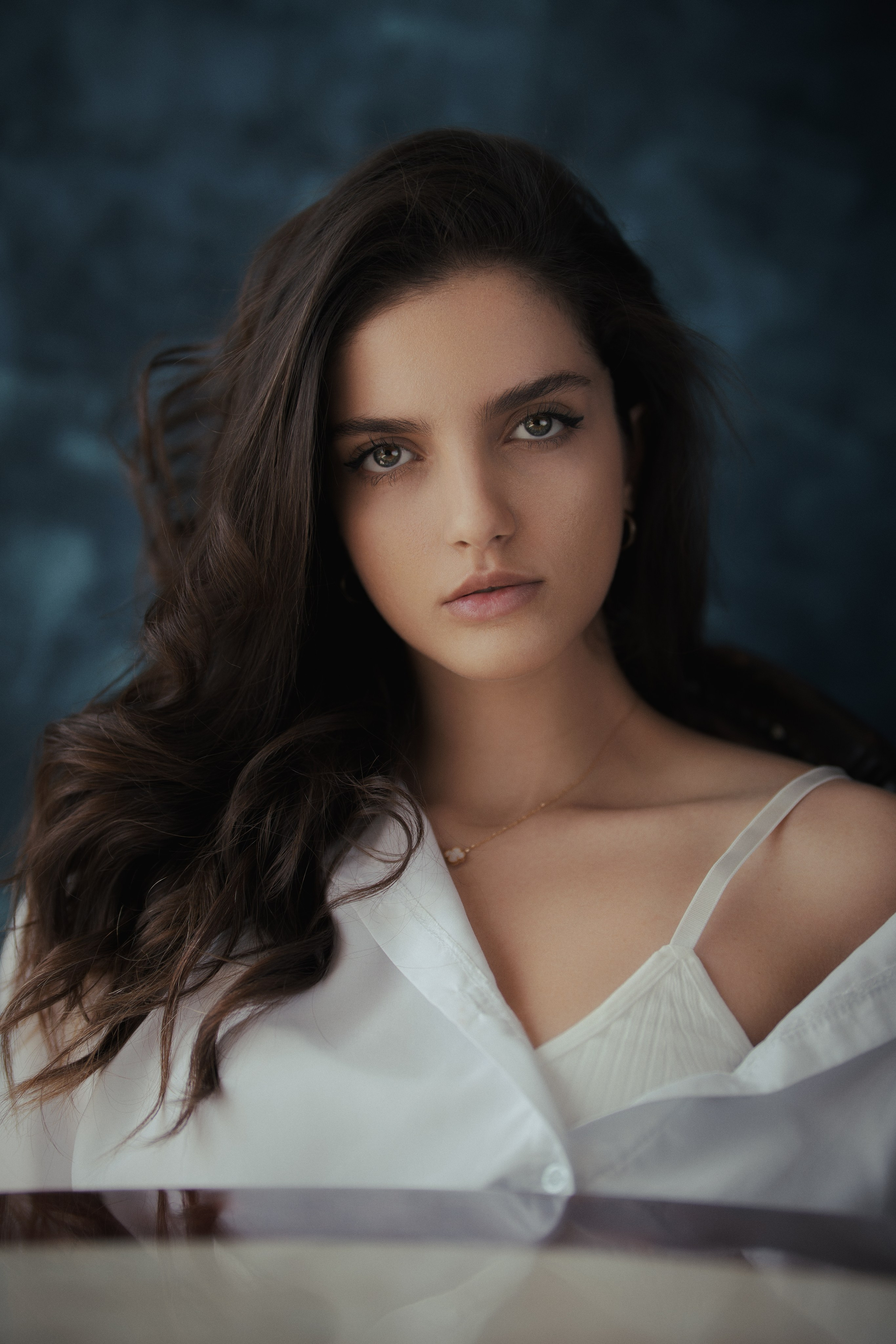 Professional female portrait photography by Mehran Hadad featuring a young woman with long dark hair, soft cinematic lighting, and elegant beauty styling.