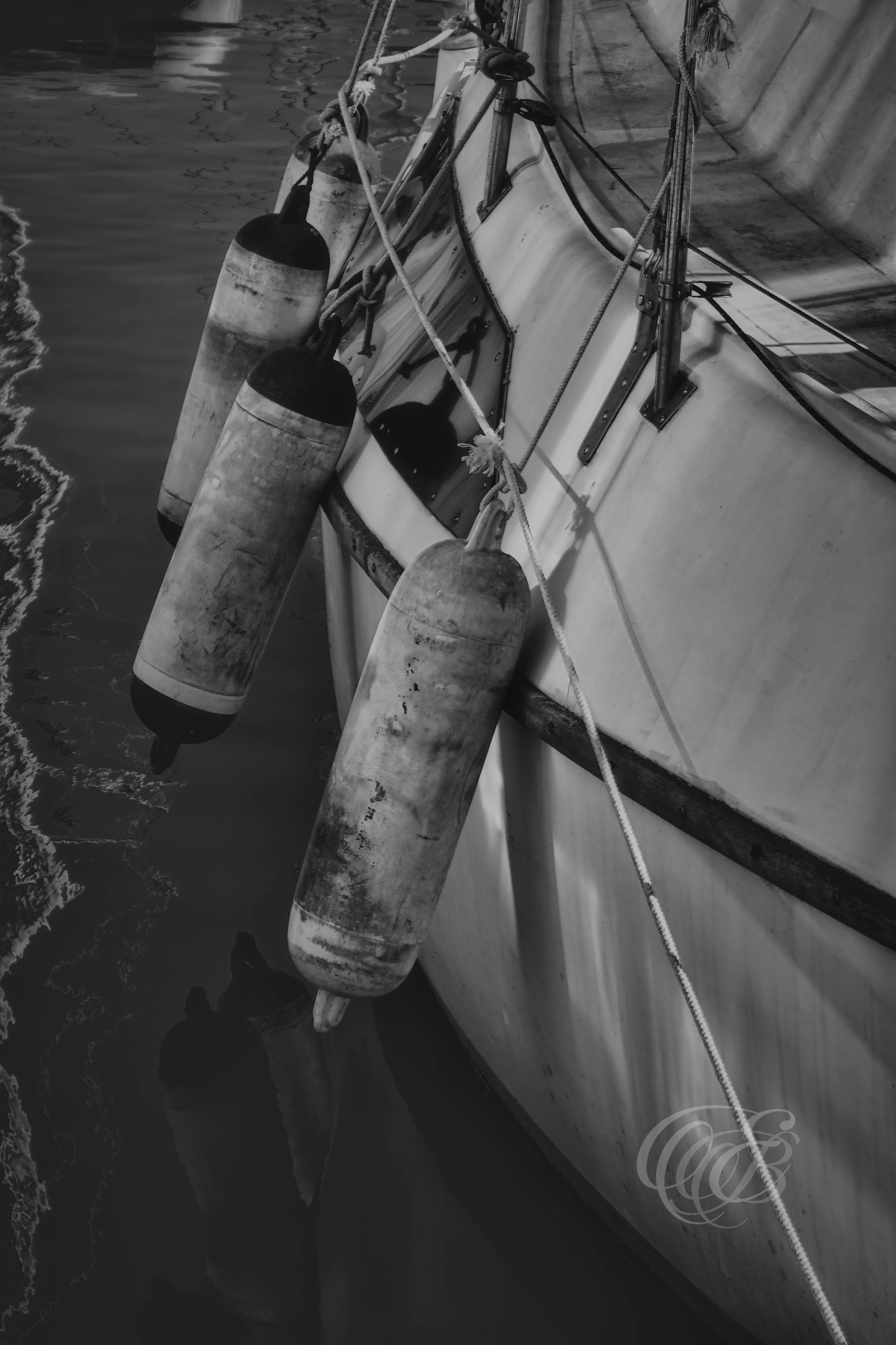 Mallorca’s harbors have long been shaped by the steady presence of vessels that connect the island to its maritime surroundings. Presented in a black and white matte style, this photograph shifts the focus toward form, surface detail, and tonal contrast, creating a quieter interpretation of the waterfront scene. The restrained palette evokes a sense of continuity between past and present, reflecting the enduring relationship between Mallorca and the Mediterranean. Eduardo Bartoli Photography.