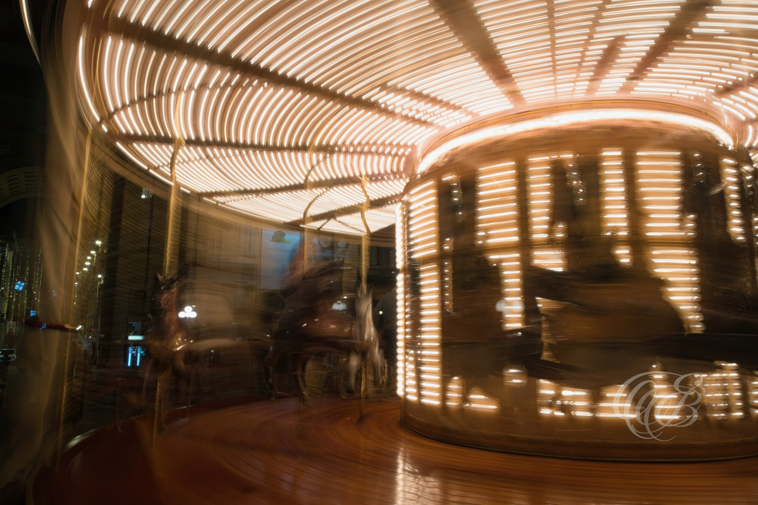 Florence, Italy—Long-exposure photography transforms the lights of a moving carousel into flowing patterns of color and motion, creating an abstract interpretation of a familiar scene. Set within the historic atmosphere of Florence, the image combines movement, light, and visual rhythm in a way that extends beyond simple documentation. Eduardo Bartoli Photography.