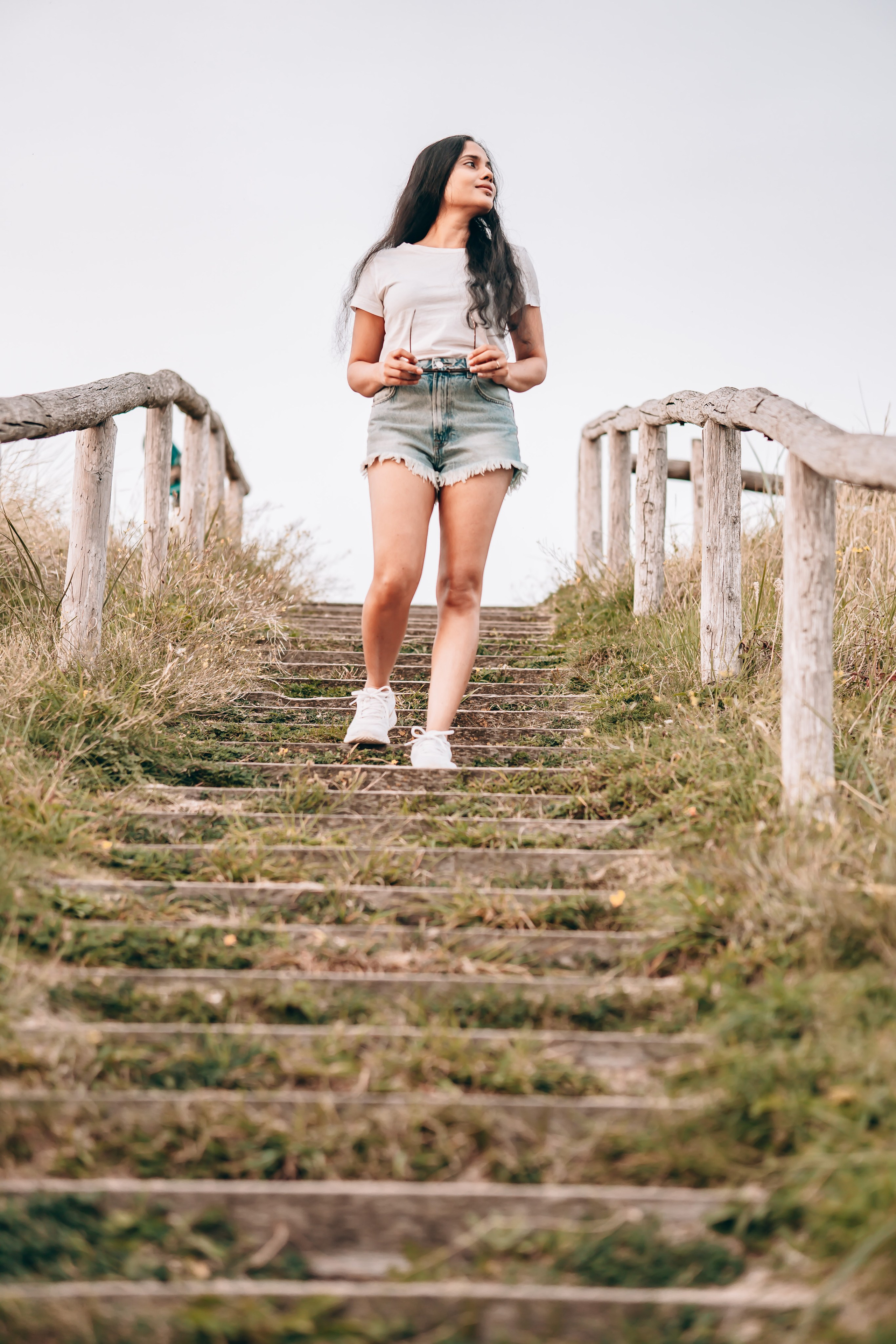 Woman walking down stairs close to the beach