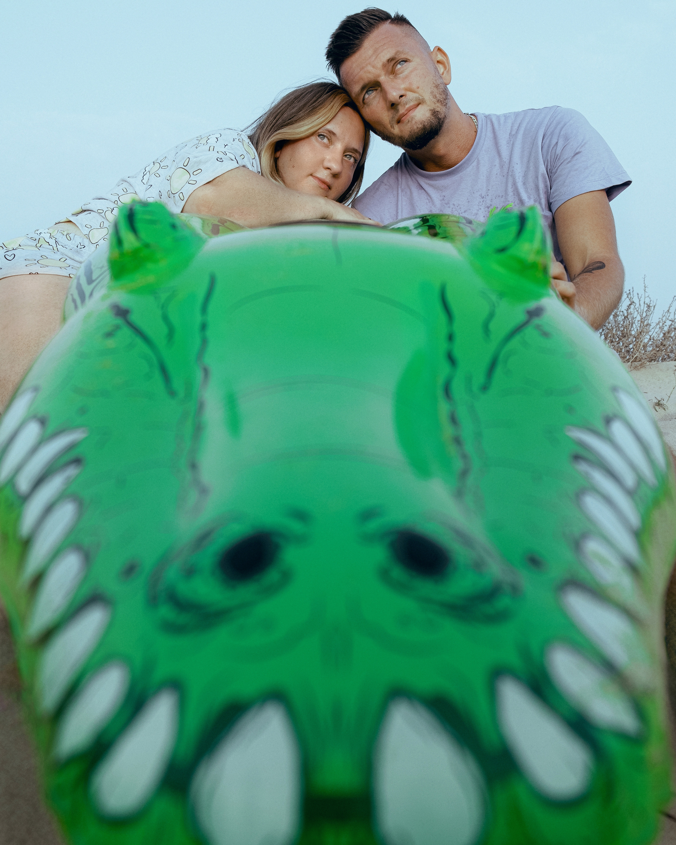 Crazy love story on the beach with an inflatable crocodile