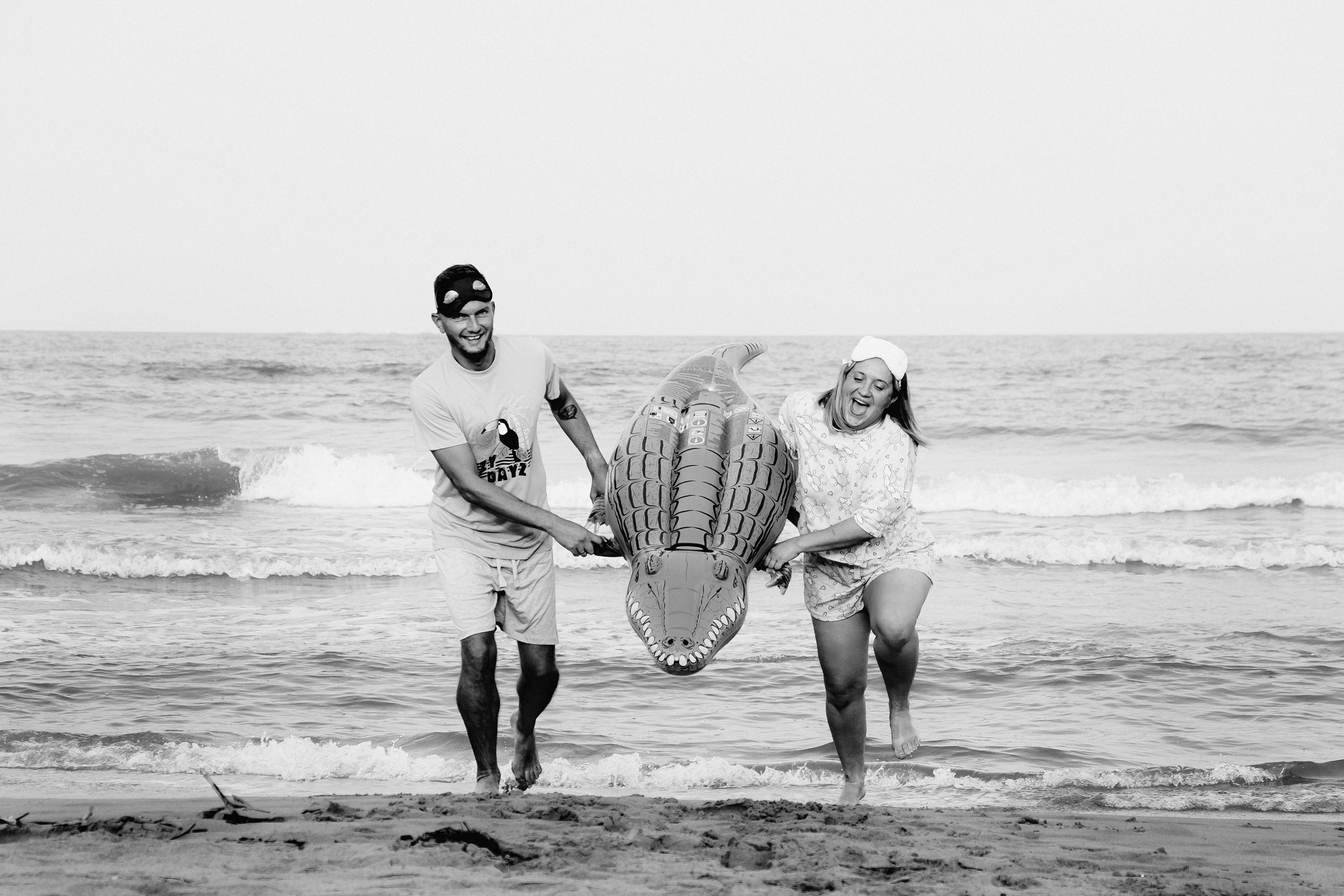 Crazy love story on the beach with an inflatable crocodile