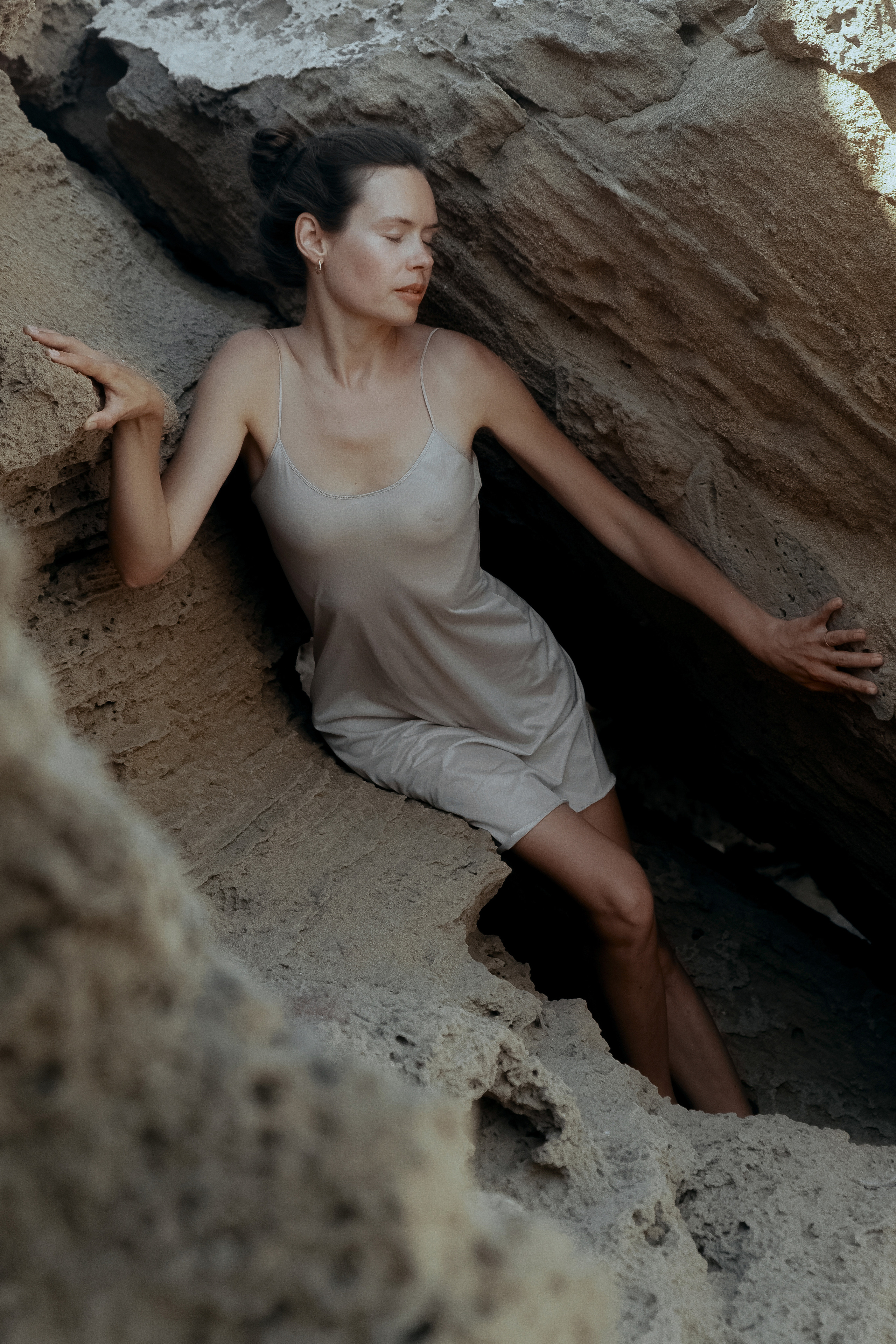 Conceptual photo session on a rocky beach